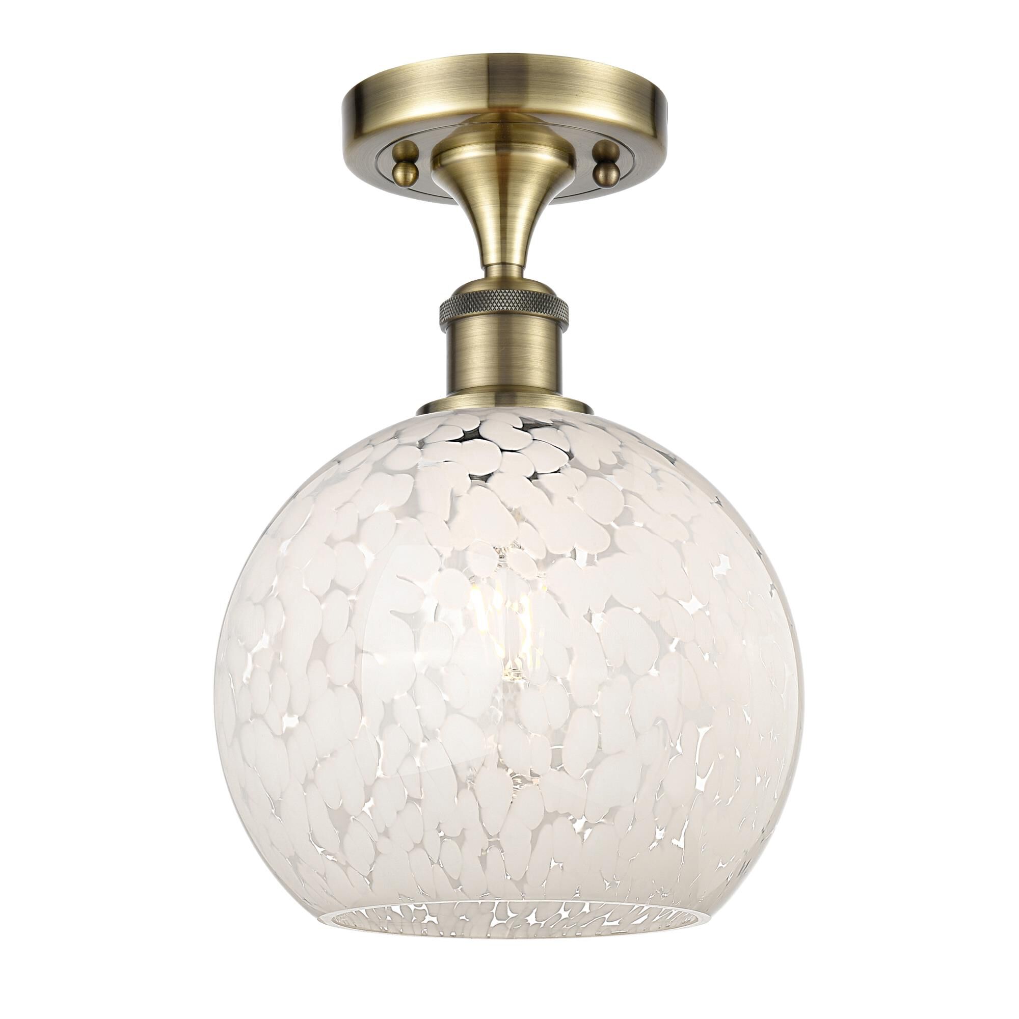 Shown in Antique Brass finish and White Mouchette glass