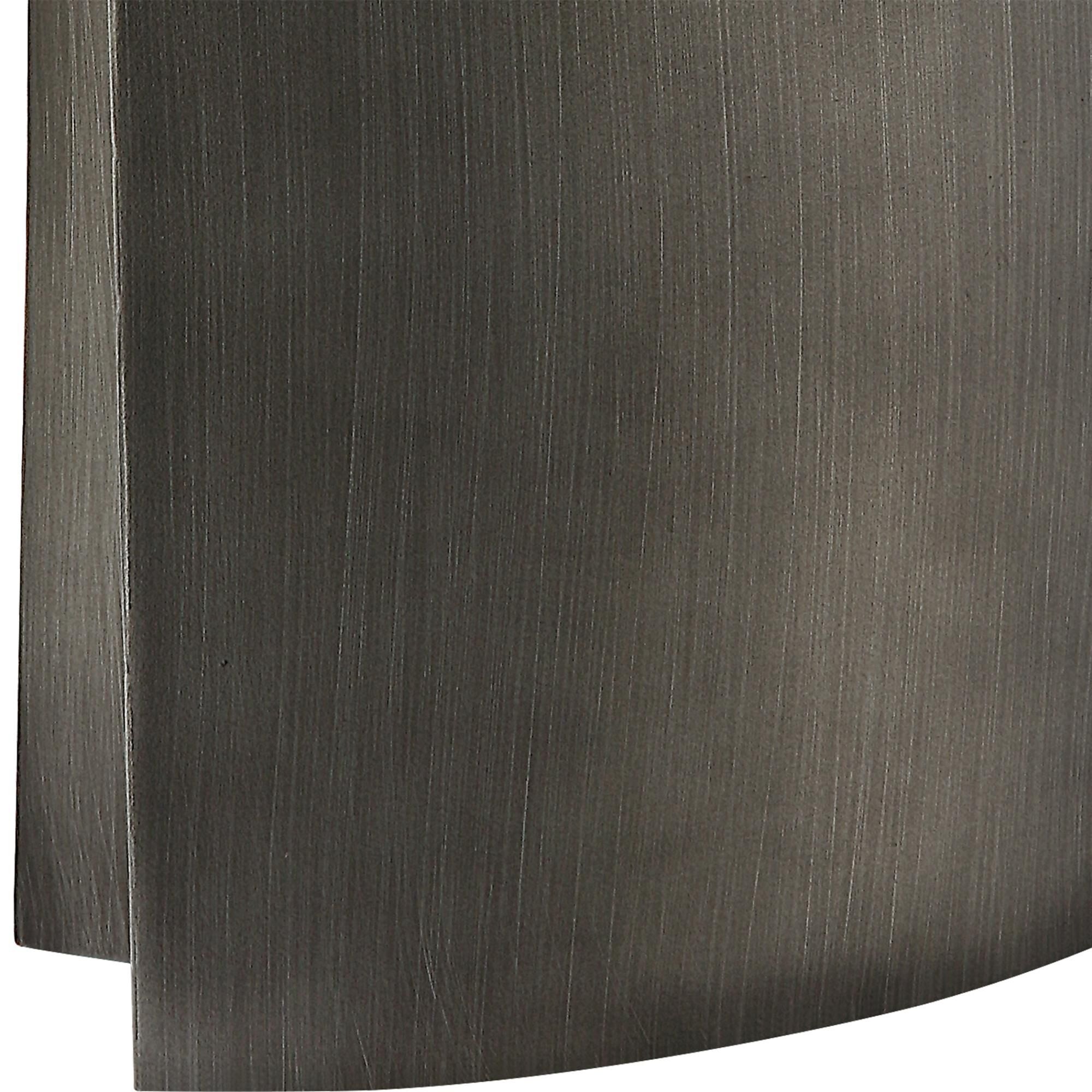 Shown in This Contemporary Sculptural Design Showcases A Tapered Silhouette With A Deep Channel Down The Side finish and Oval Drum Hardback shade