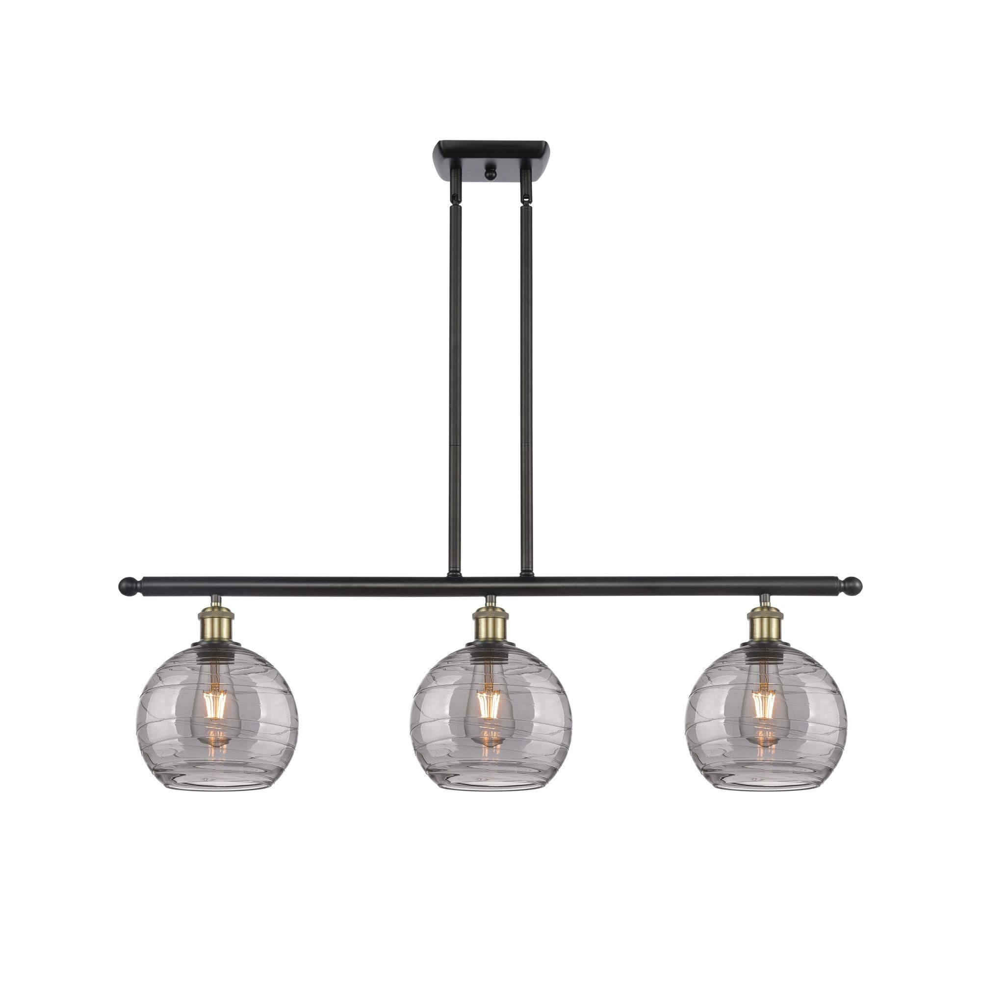 Shown in Black Antique Brass finish and Light Smoke Deco Swirl glass