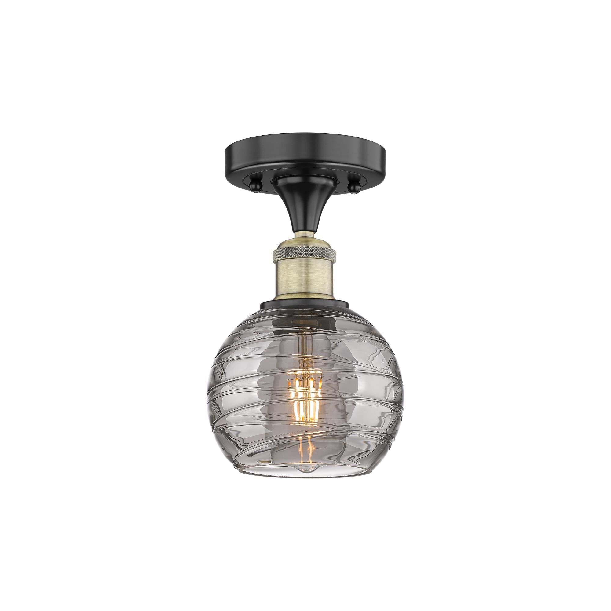 Shown in Black Antique Brass finish and Light Smoke Deco Swirl glass