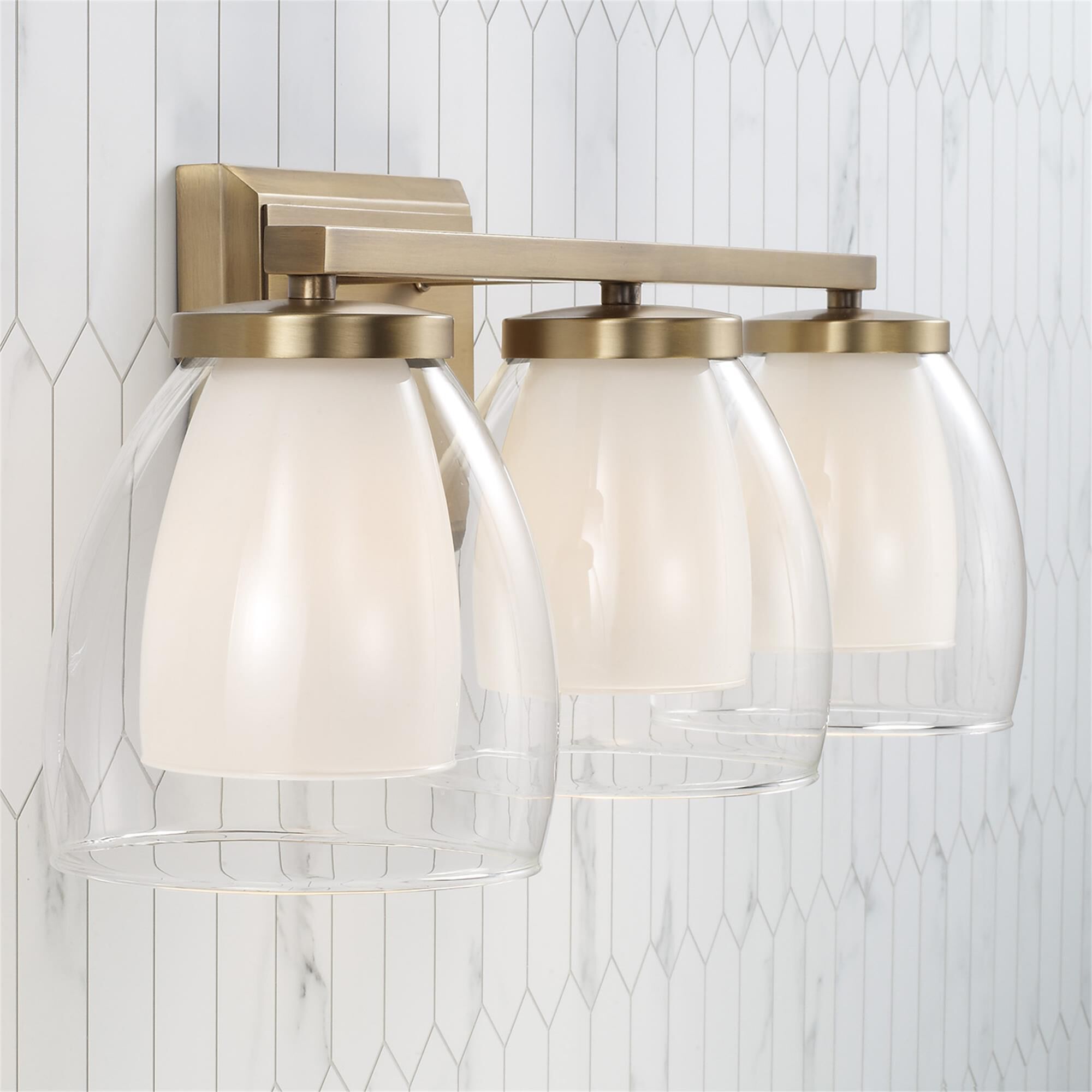 Shown in Aged Brass finish and Layered White and Clear glass