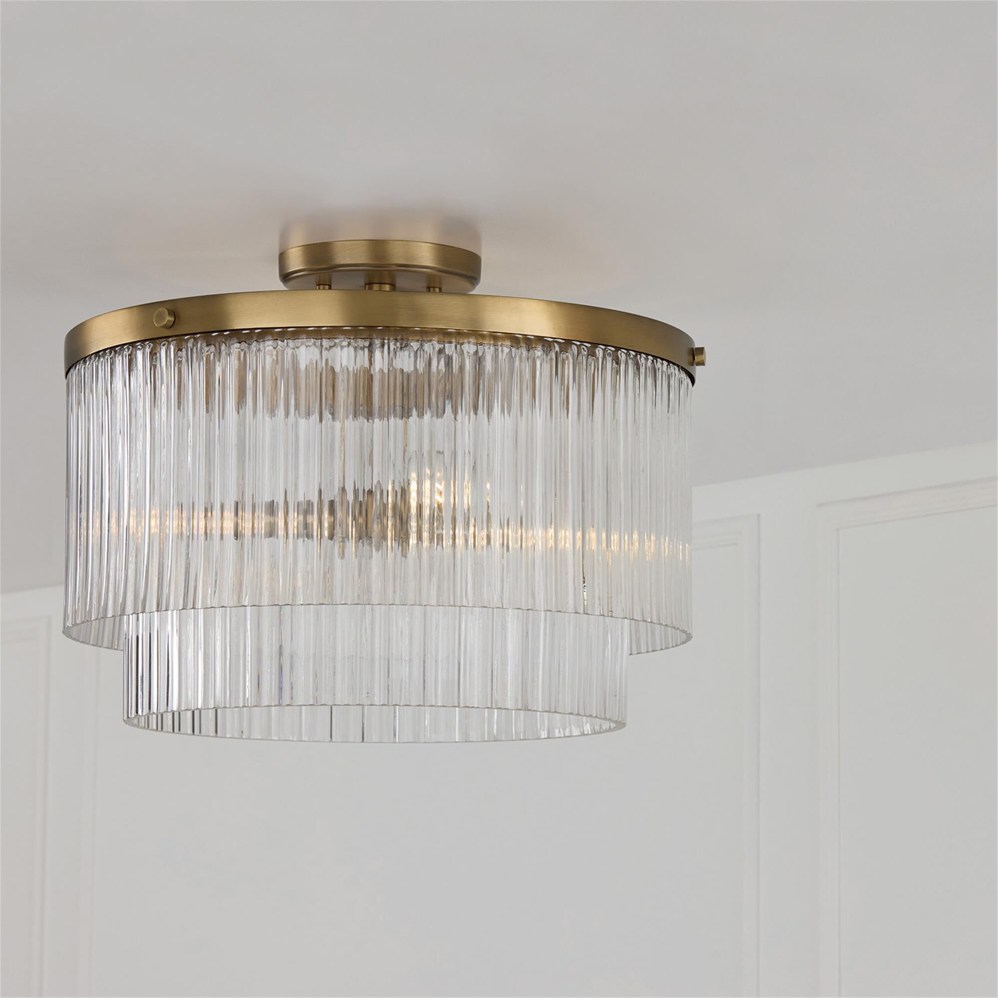 Shown in Aged Brass finish and Beveled Fluted glass