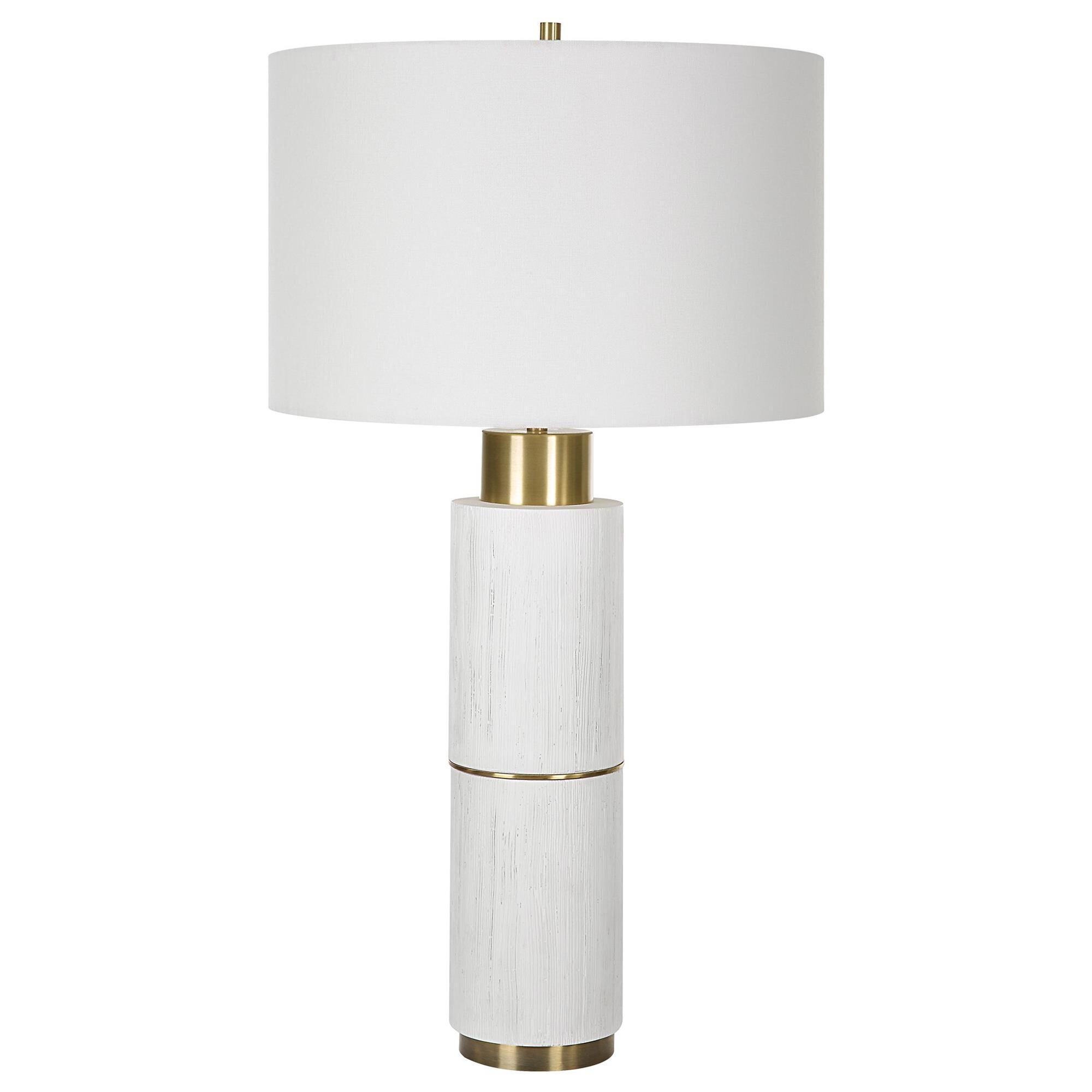 Shown in The Ruse Table Lamp Showcases A Whitewashed Wood Look With A Noticeable Textured Finish, Accented By finish and Round Drum Hardback shade