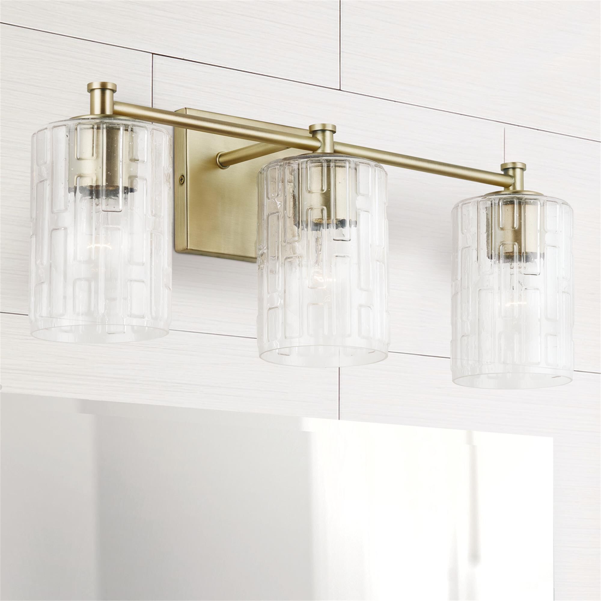 Shown in Aged Brass finish and Clear Embossed glass