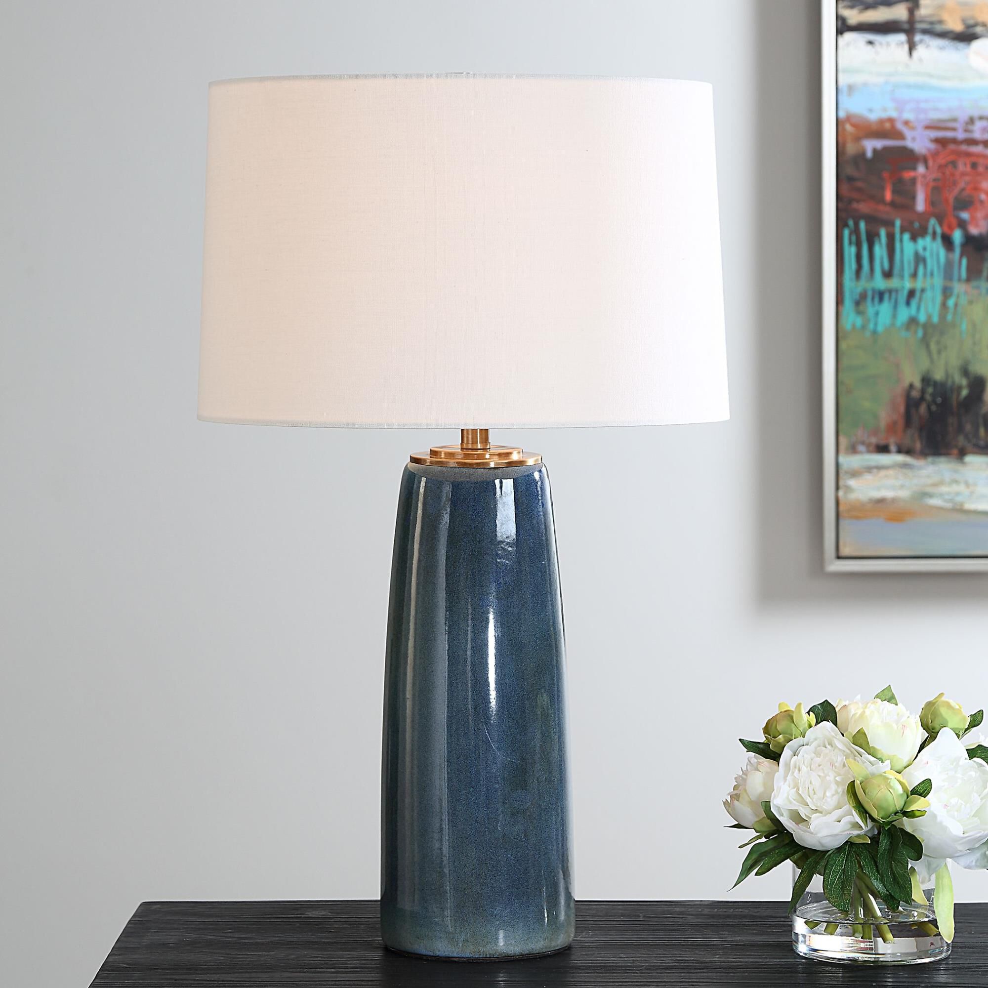 Shown in This Ceramic Table Lamp Showcases A Deep Blue Glaze With Rustic Undertones, Accented With Plated Ant finish and Round Hardback shade