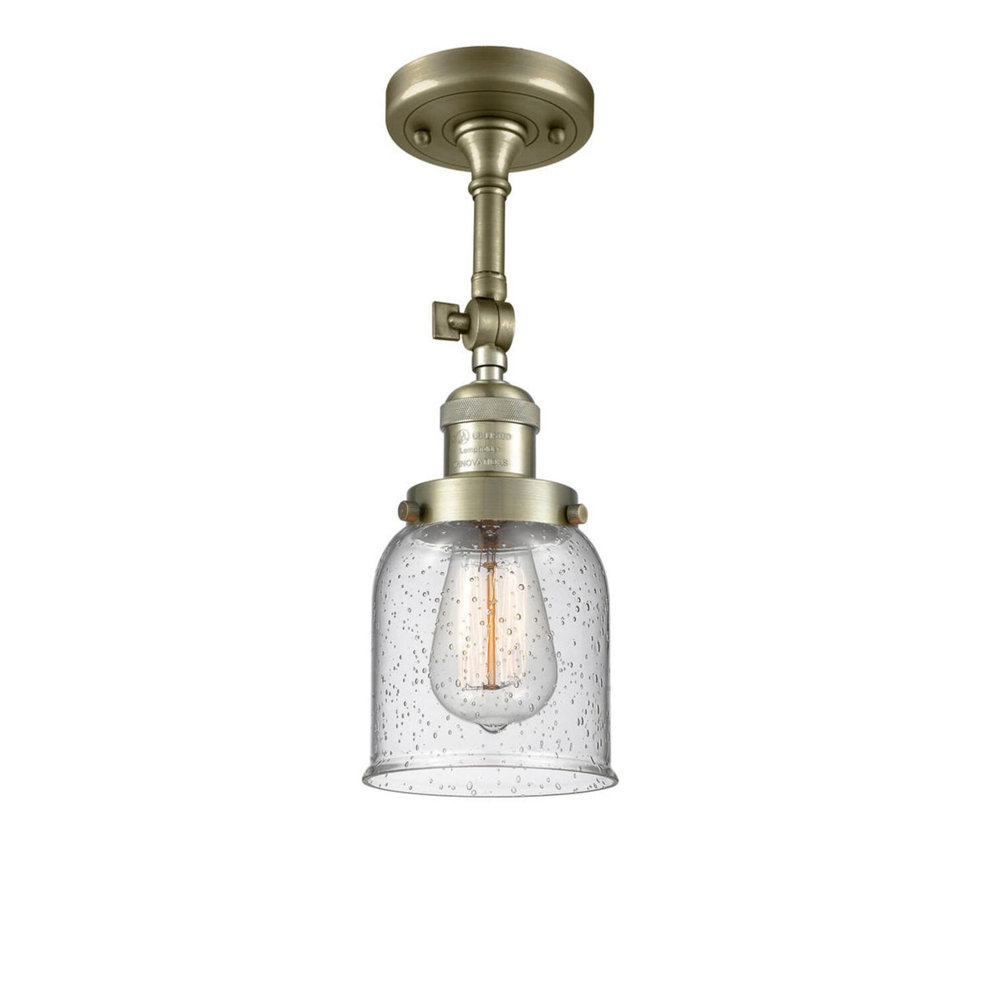 Shown in Antique Brass finish and Seedy glass and None accent