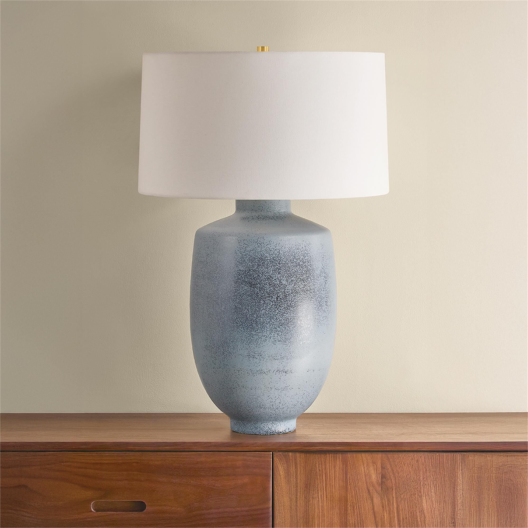 Shown in Aged Brass and Ceramic Oceanside finish and White Linen shade