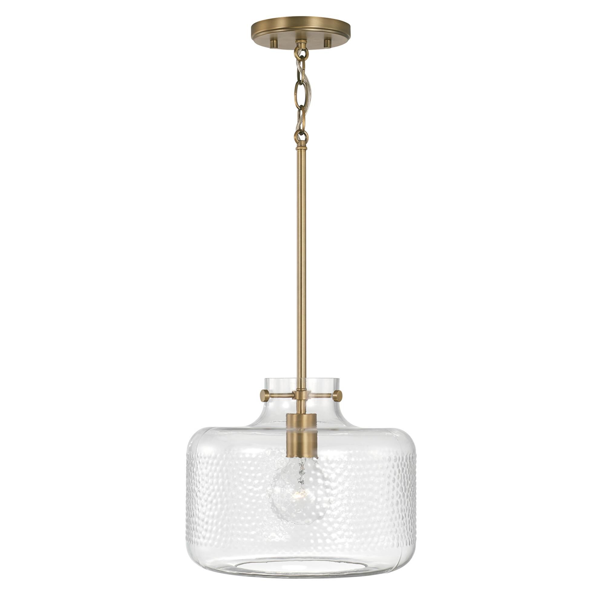 Shown in Aged Brass finish and Clear Pebbled glass