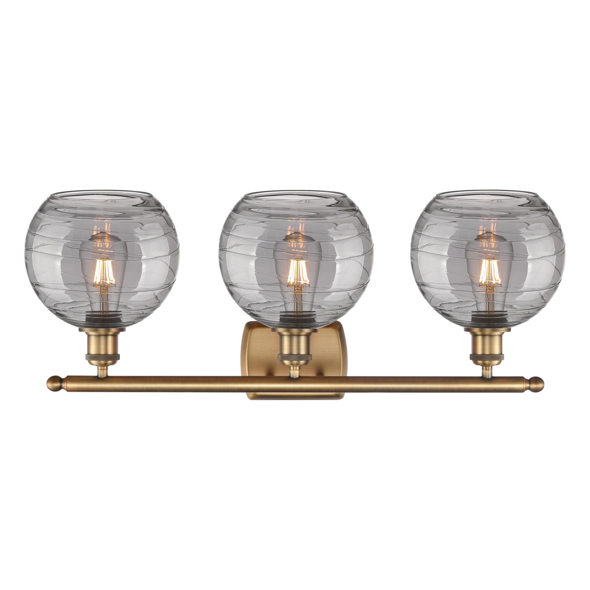 Shown in Brushed Brass finish and Light Smoke Deco Swirl glass