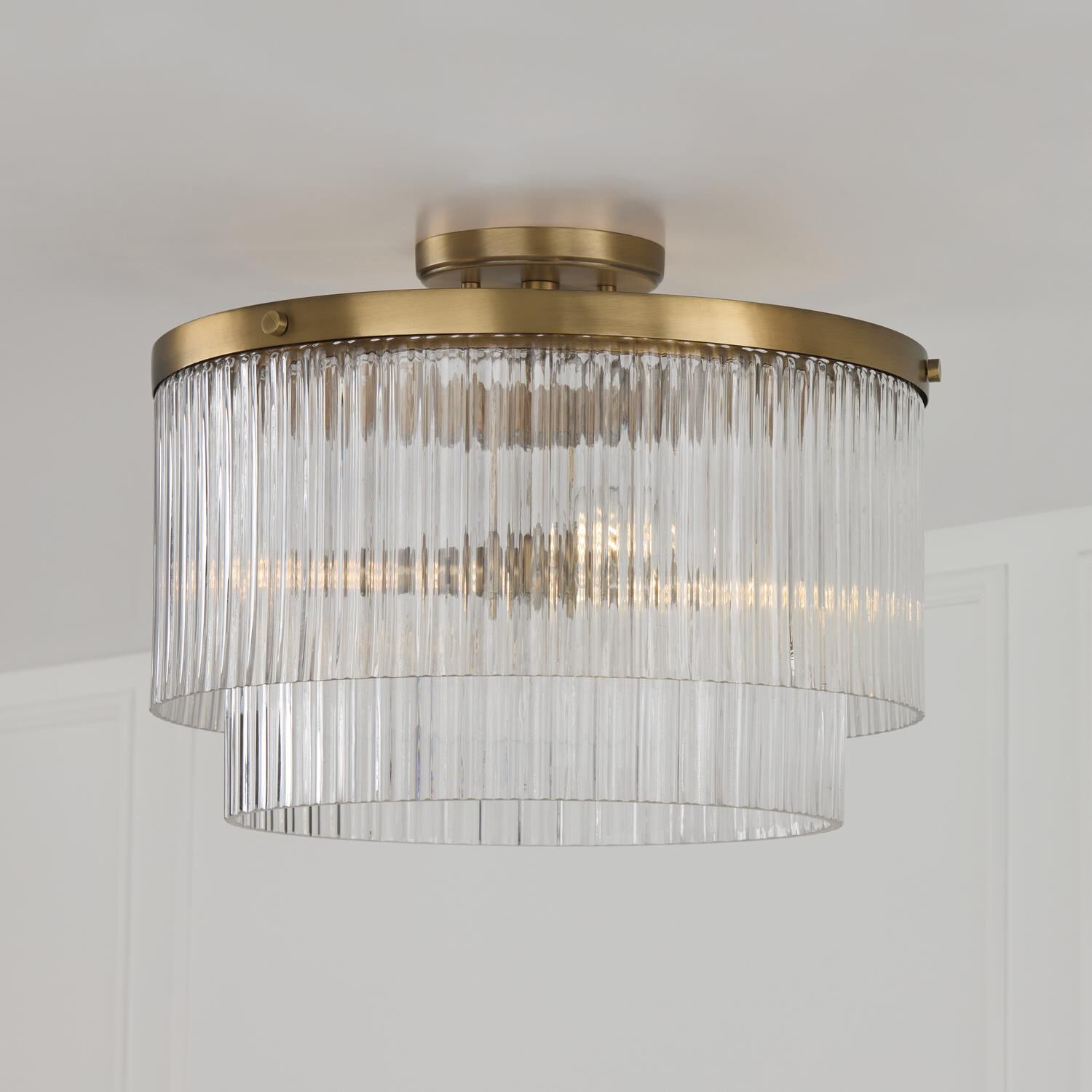 Shown in Aged Brass finish and Beveled Fluted glass