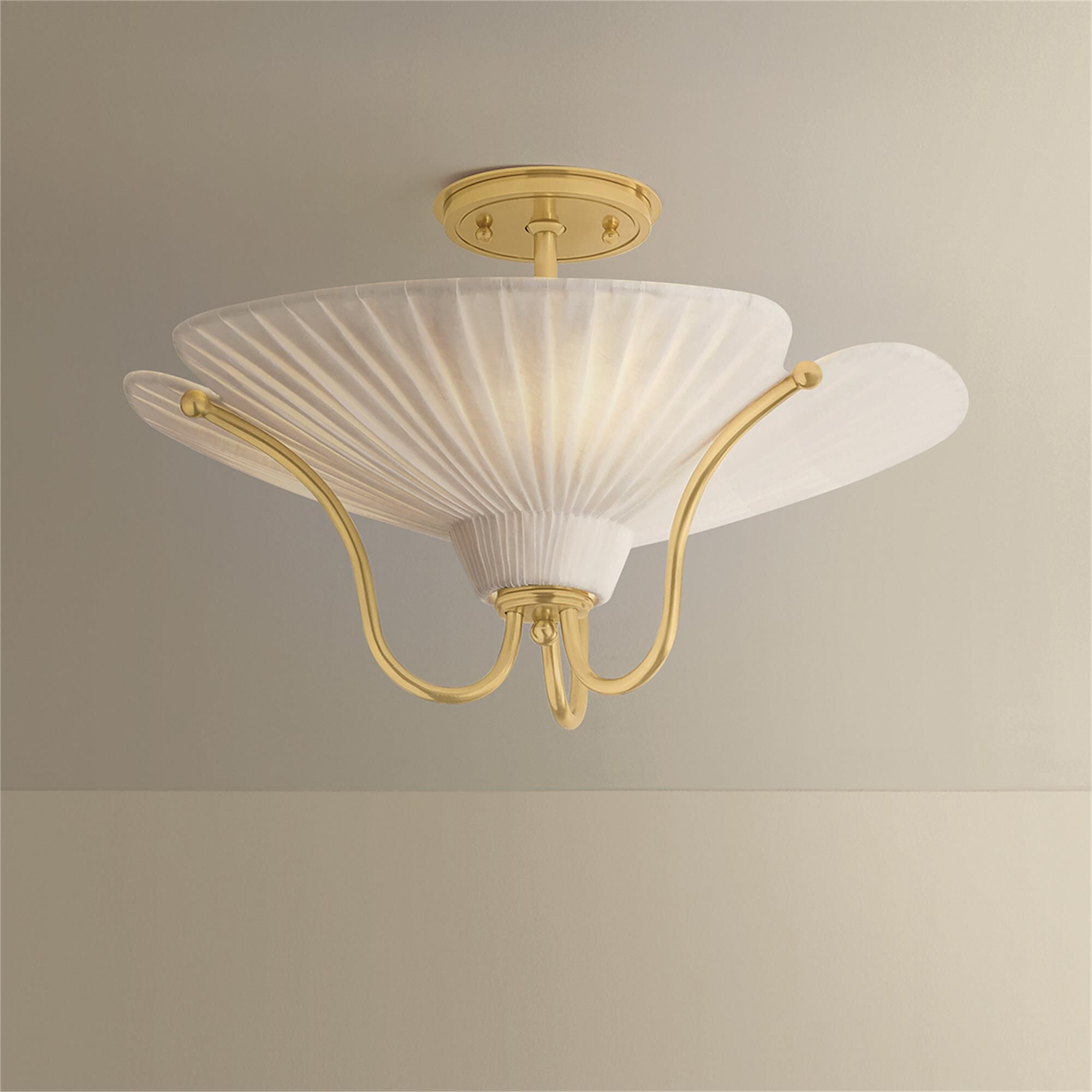 Shown in Aged Brass finish and Ivory Linen shade