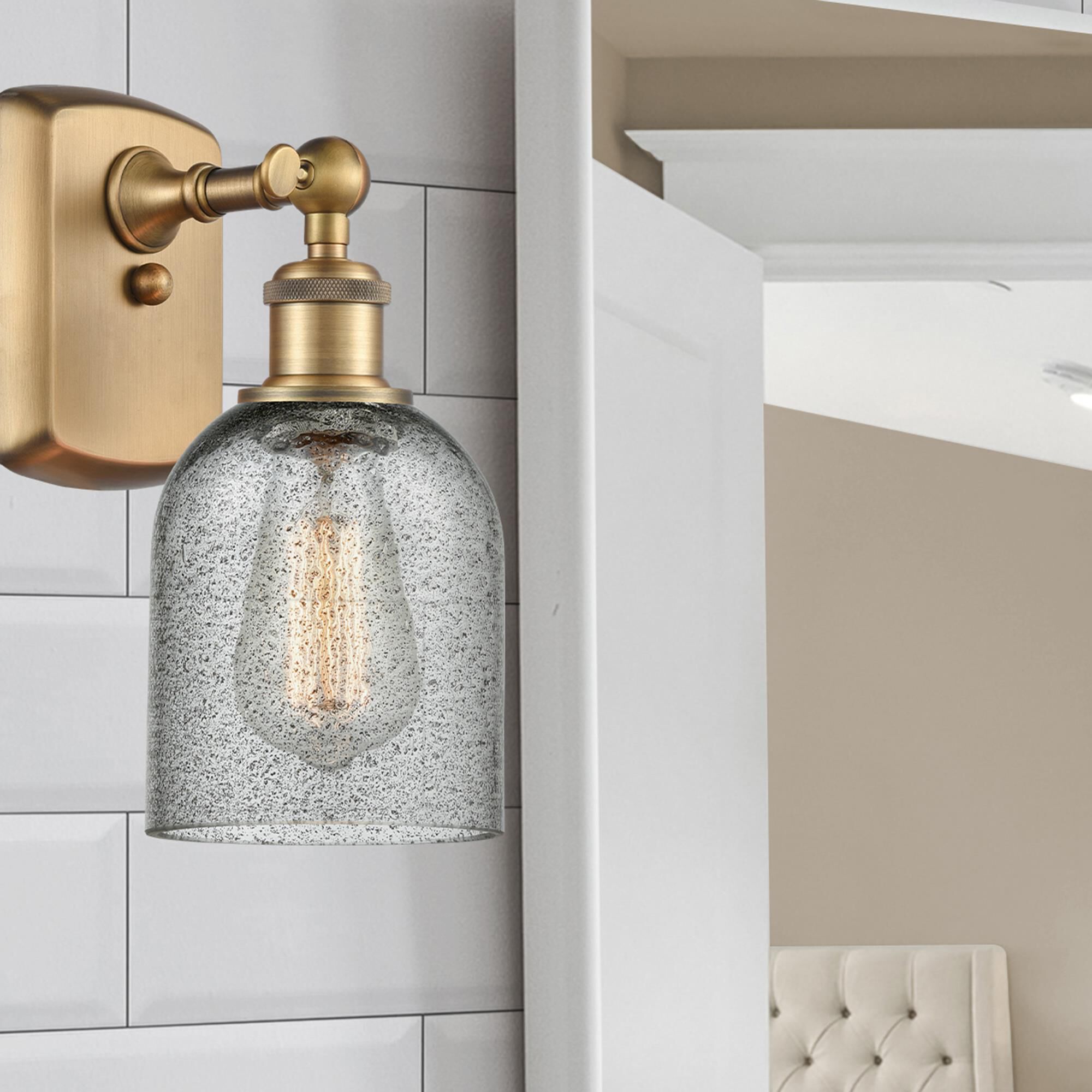 Shown in Brushed Brass finish and Bell glass and Glass shade