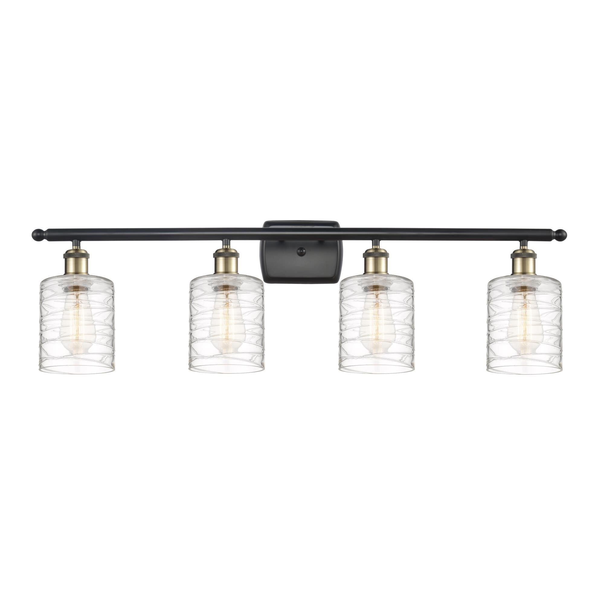 Shown in Black Antique Brass finish and Deco Swirl Cobbleskill glass