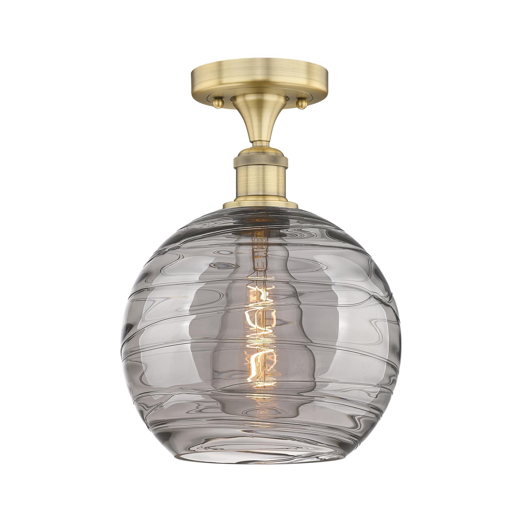 Shown in Brushed Brass finish and Light Smoke Deco Swirl glass