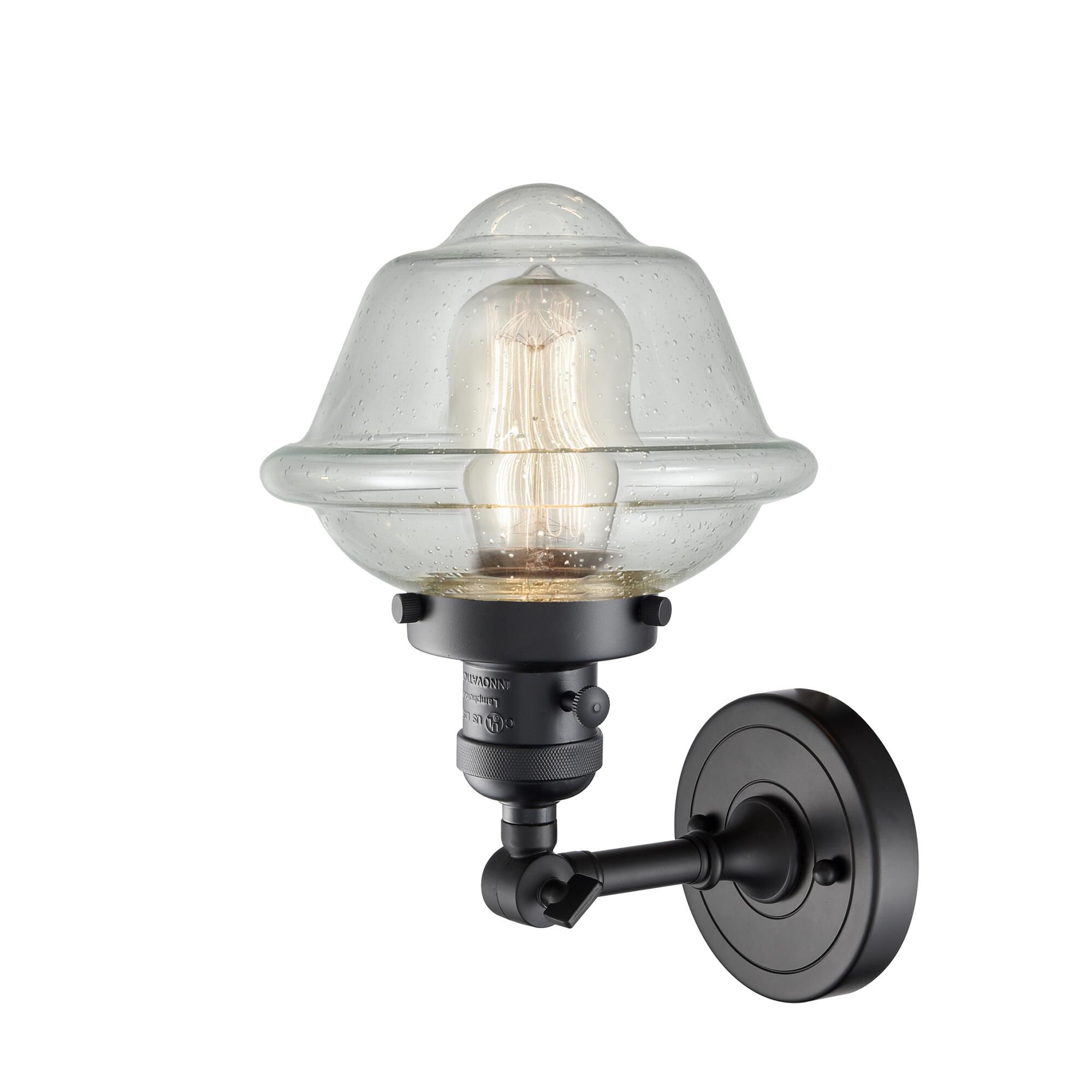 Shown in Matte Black finish and Seedy glass and Switch on Socket accent