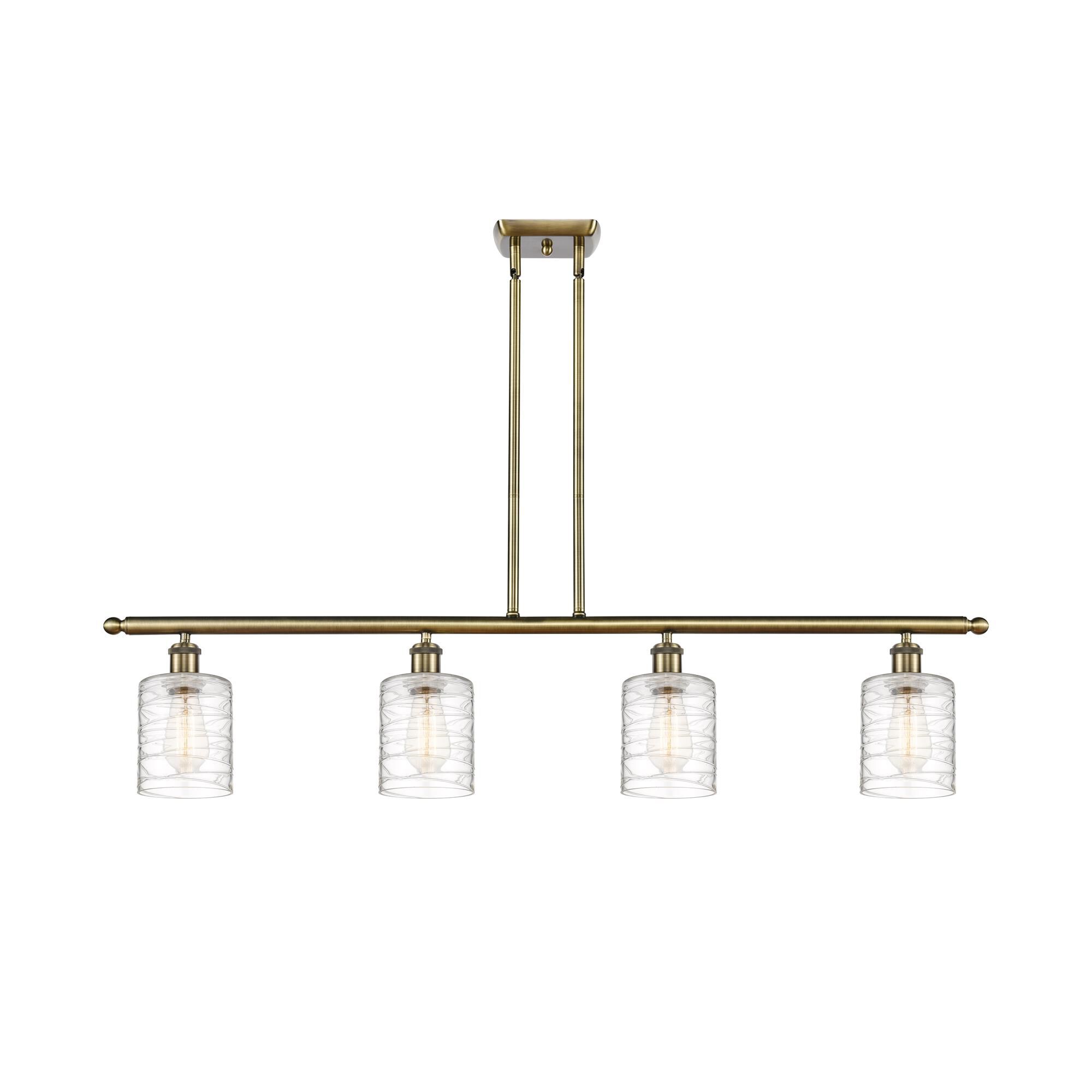 Shown in Antique Brass finish and Deco Swirl Cobbleskill glass