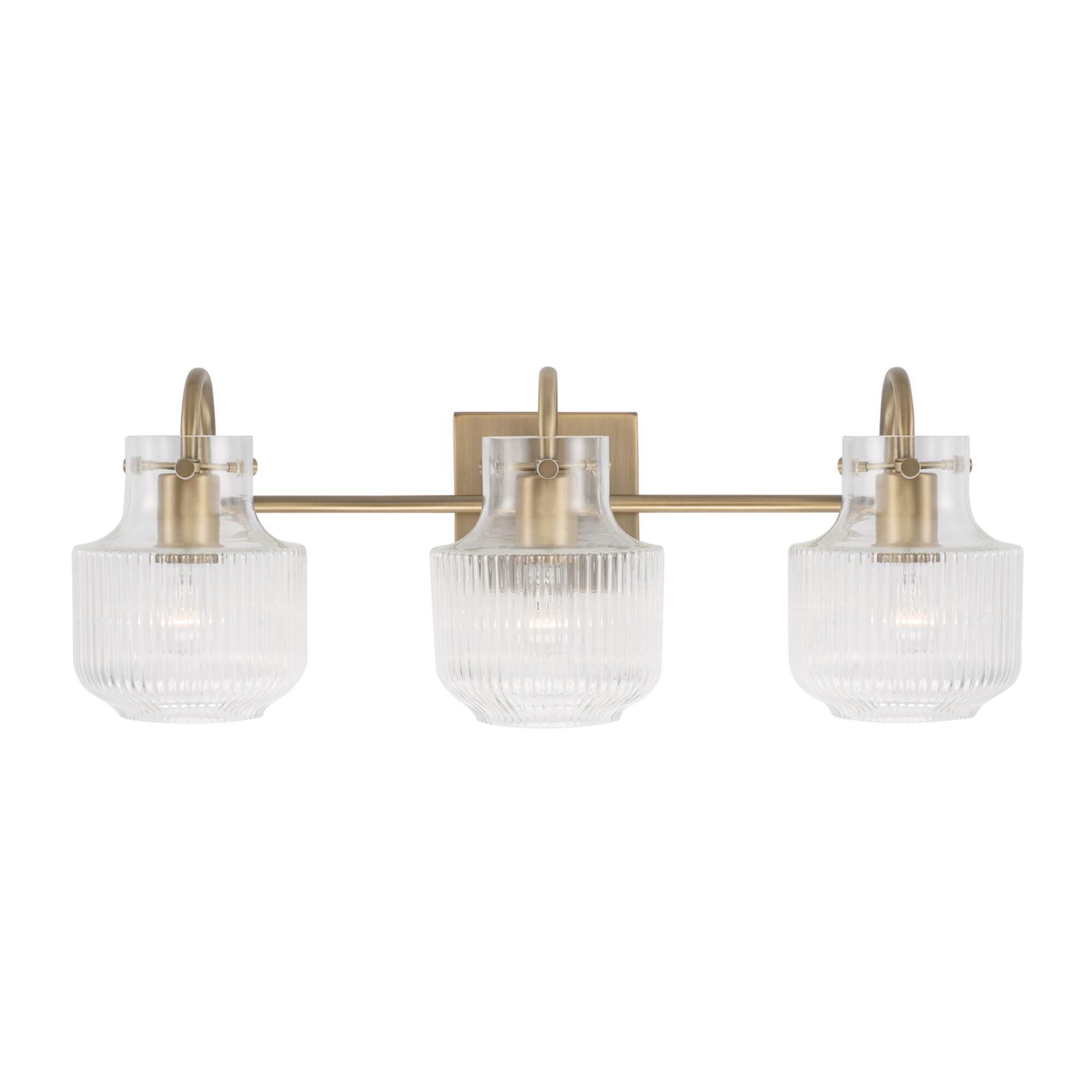Shown in Aged Brass finish and Clear Fluted glass