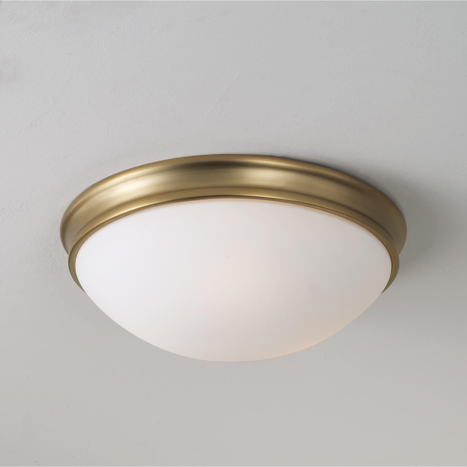 Shown in Aged Brass finish and Soft White glass