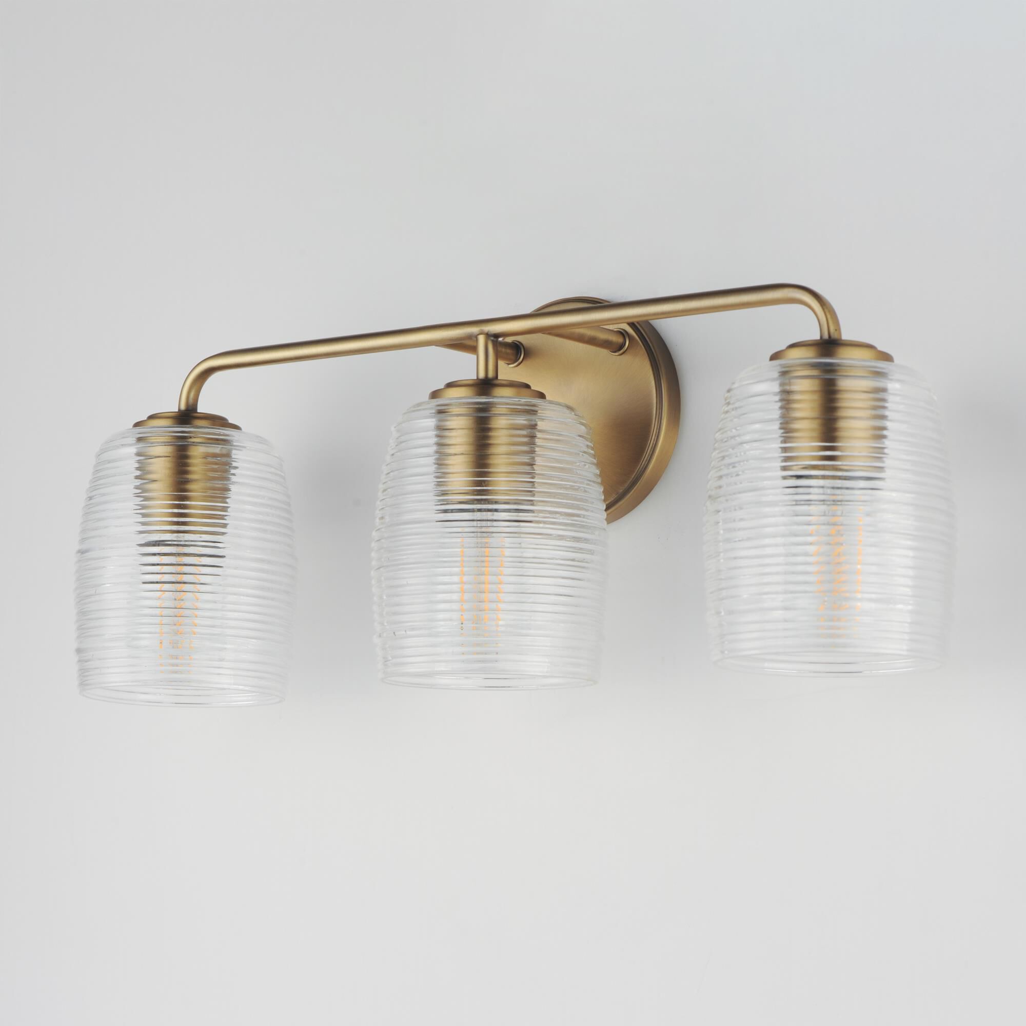 Shown in Natural Aged Brass finish and Clear Ribbed glass