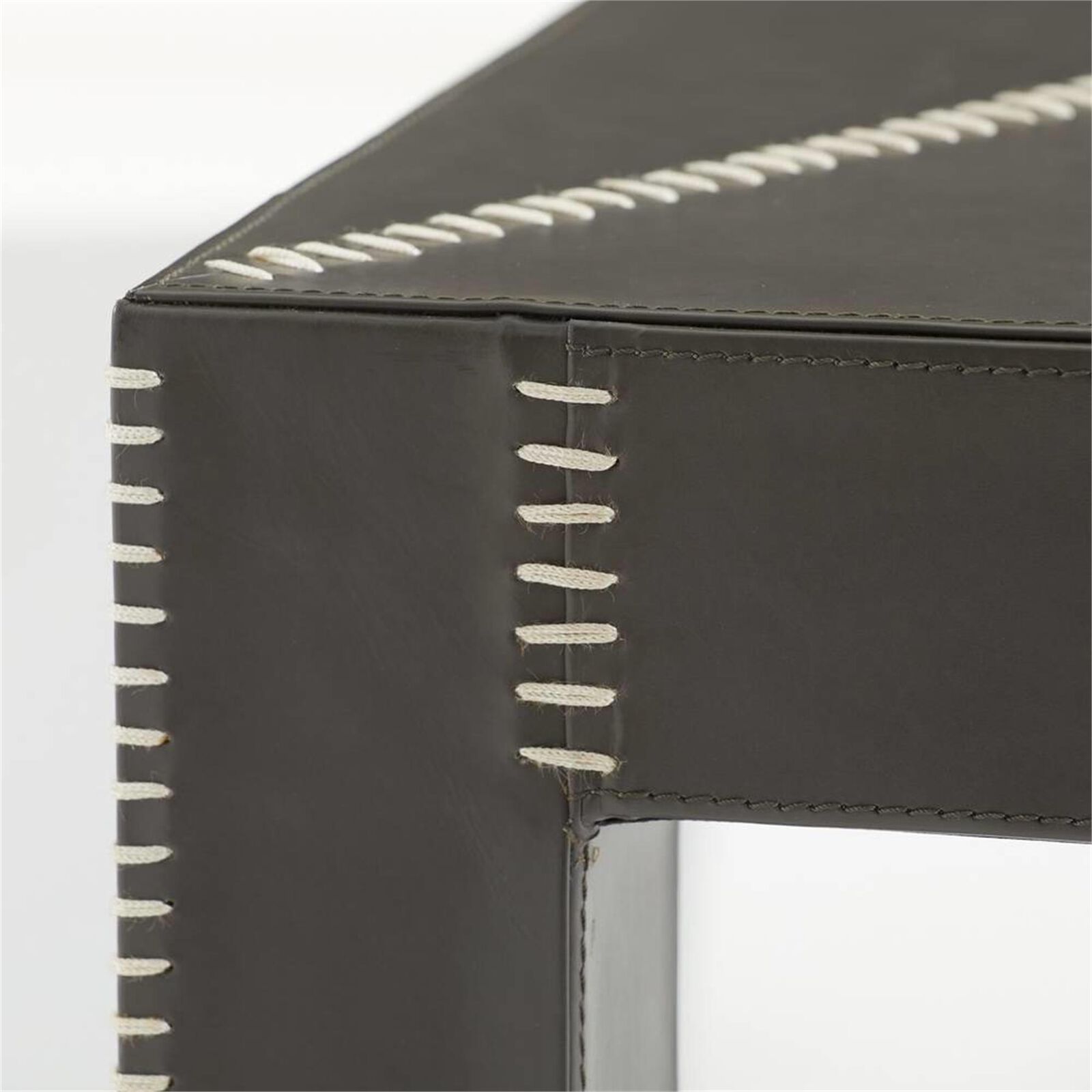 Close-up of the white stitching on the grey leather corner