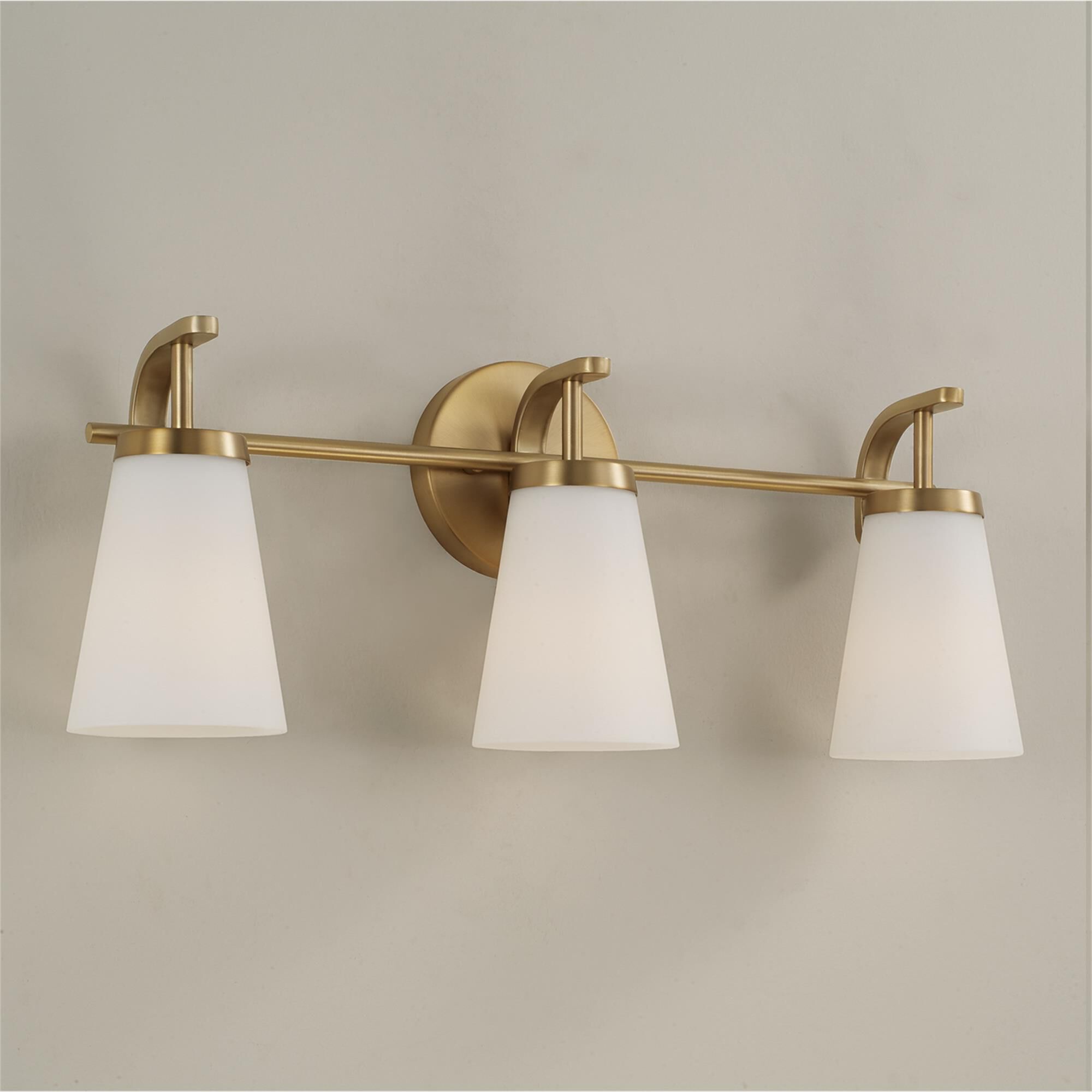 Shown in Aged Brass finish and Soft White glass