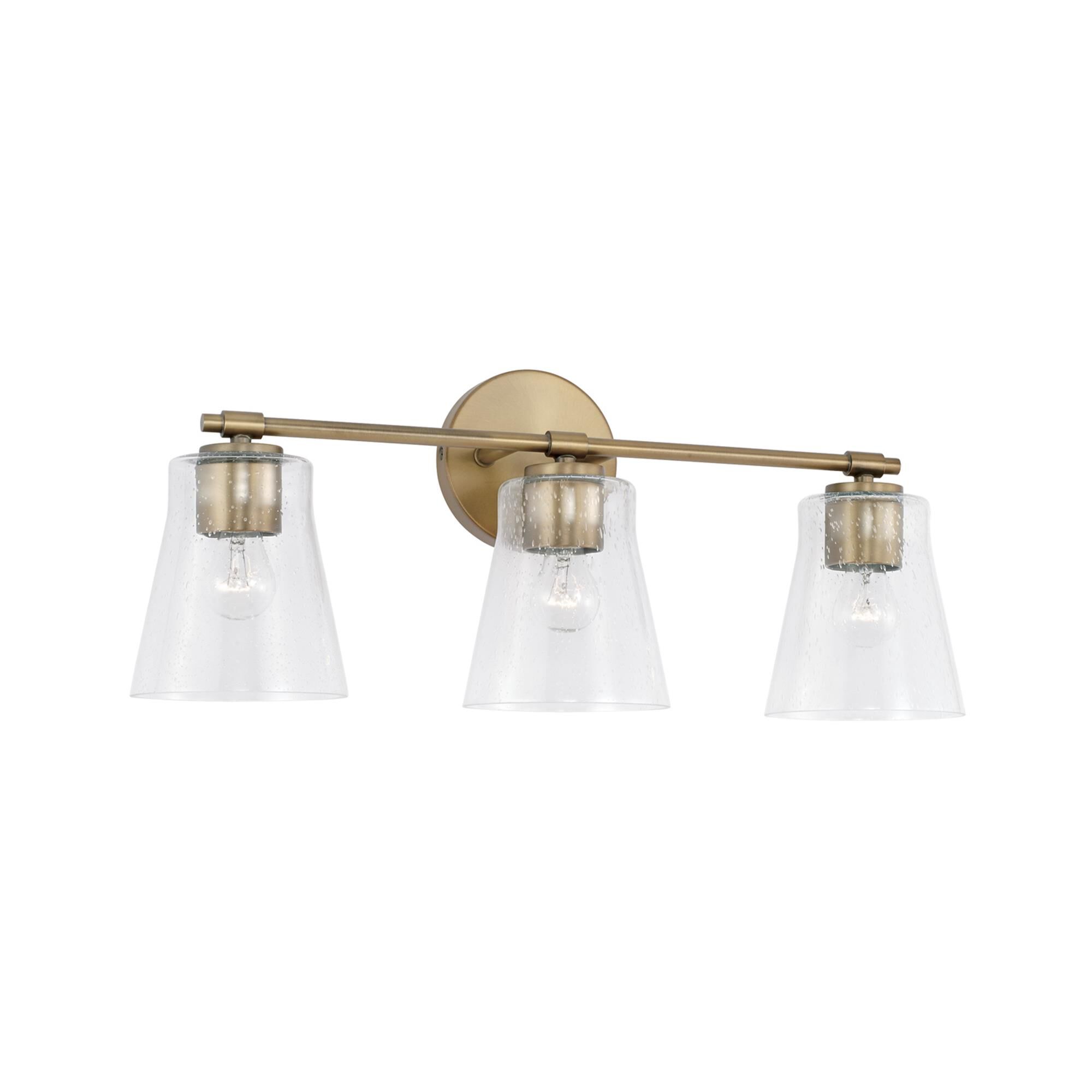 Shown in Aged Brass finish and Clear Seeded glass
