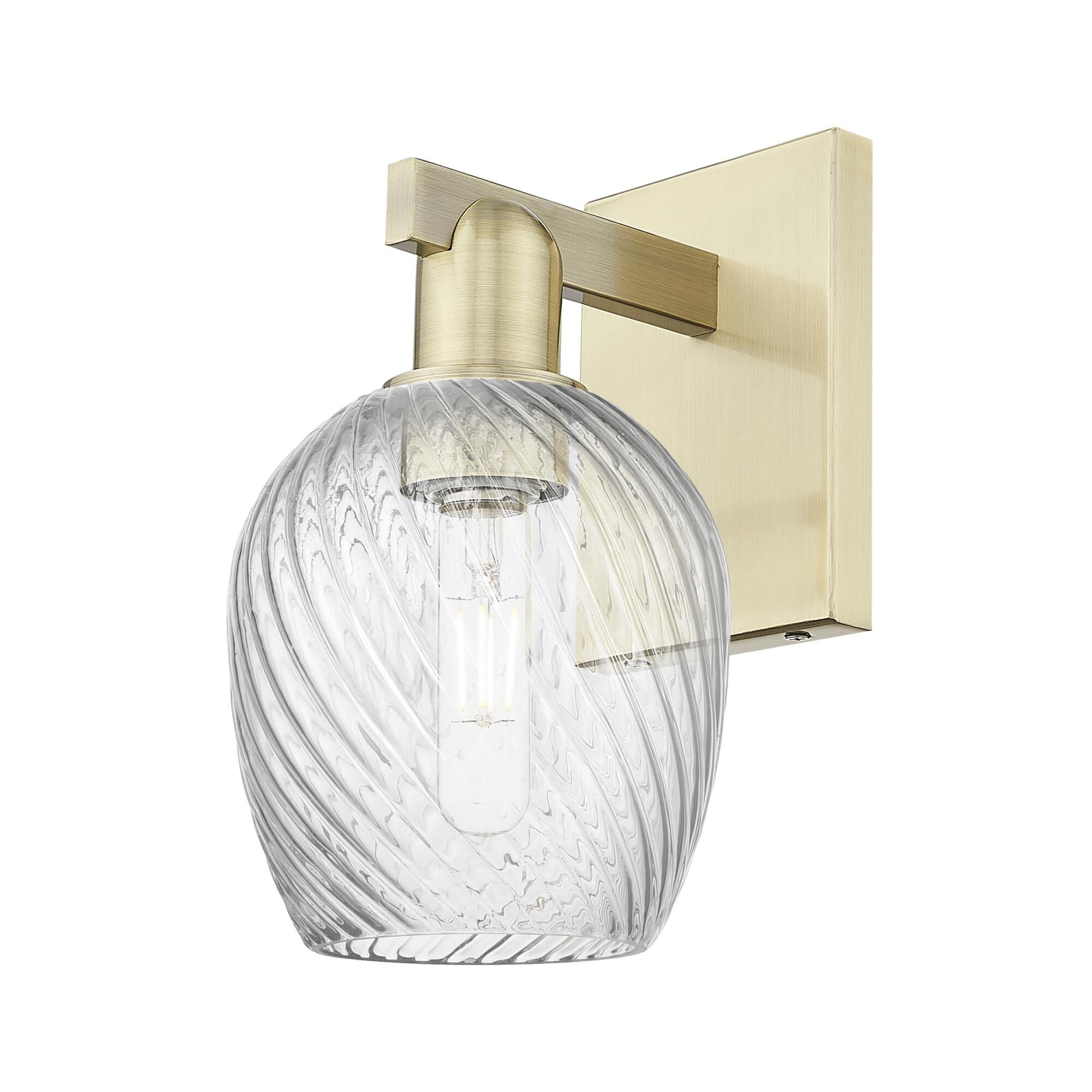 Shown in Antique Brass finish and Clear Spiral Fluted glass