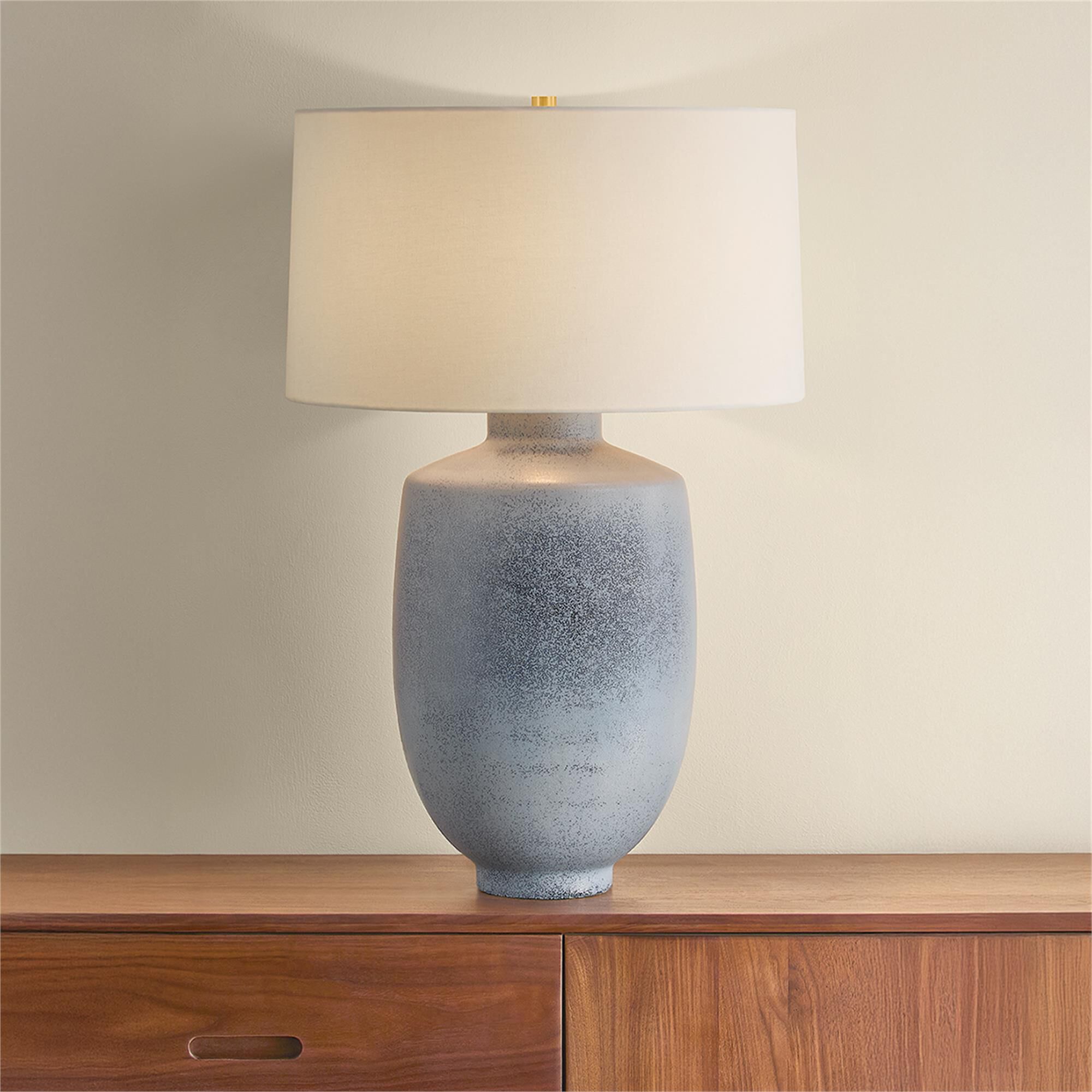 Shown in Aged Brass and Ceramic Oceanside finish and White Linen shade