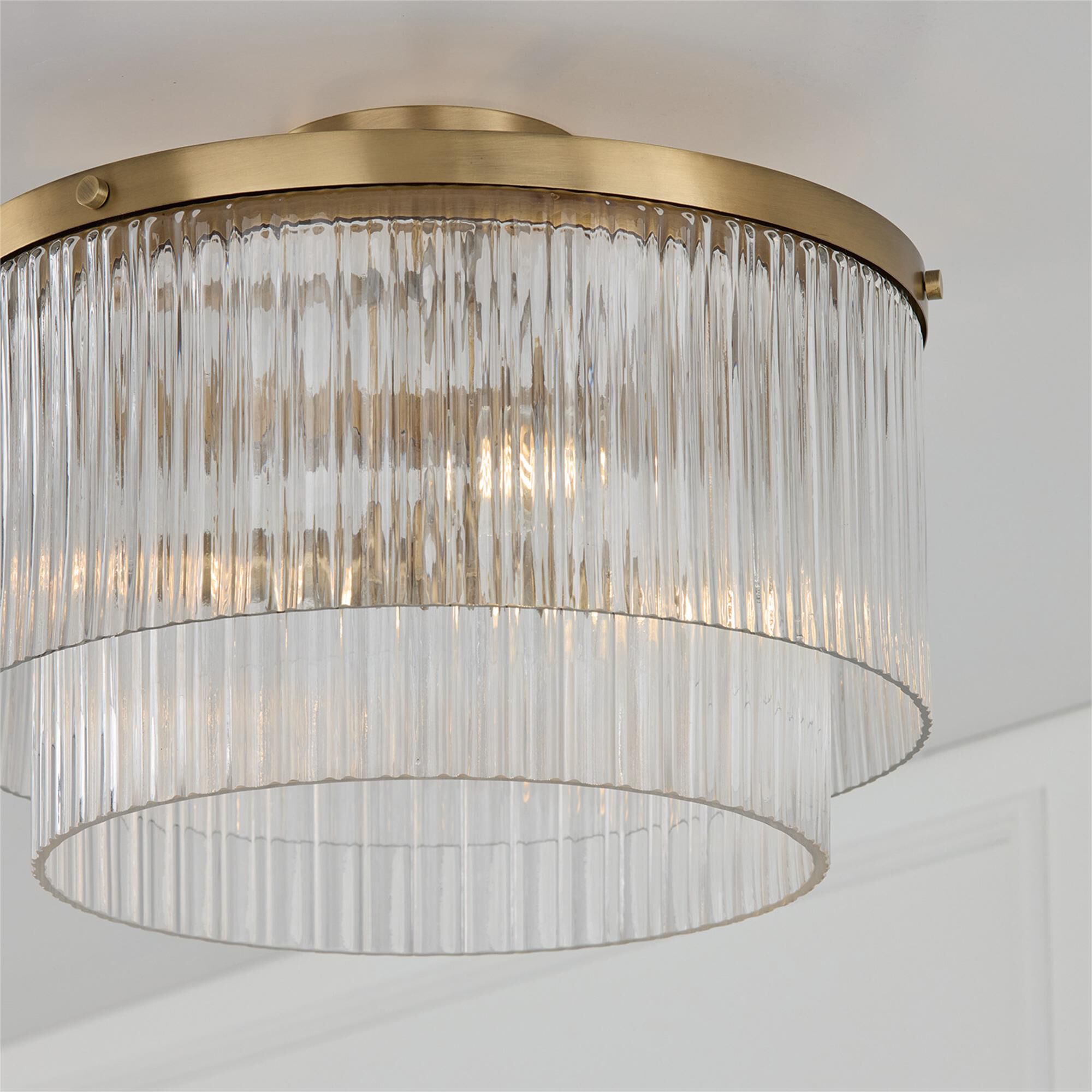 Shown in Aged Brass finish and Beveled Fluted glass