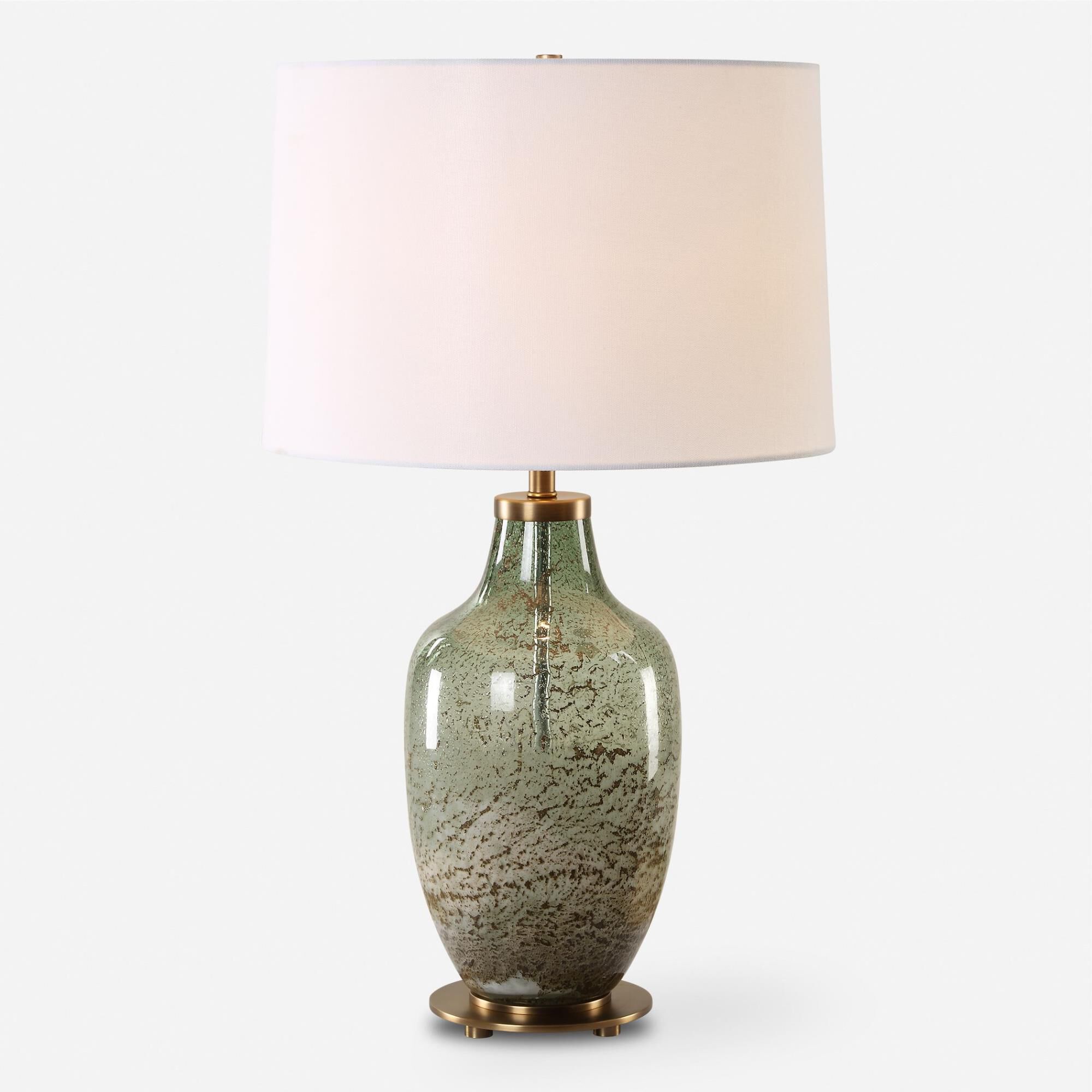 Shown in This Glass Table Lamp Features A Beautiful Blend Of Translucent Olive Green With A Subtle Ivory Wash finish and Round Hardback shade