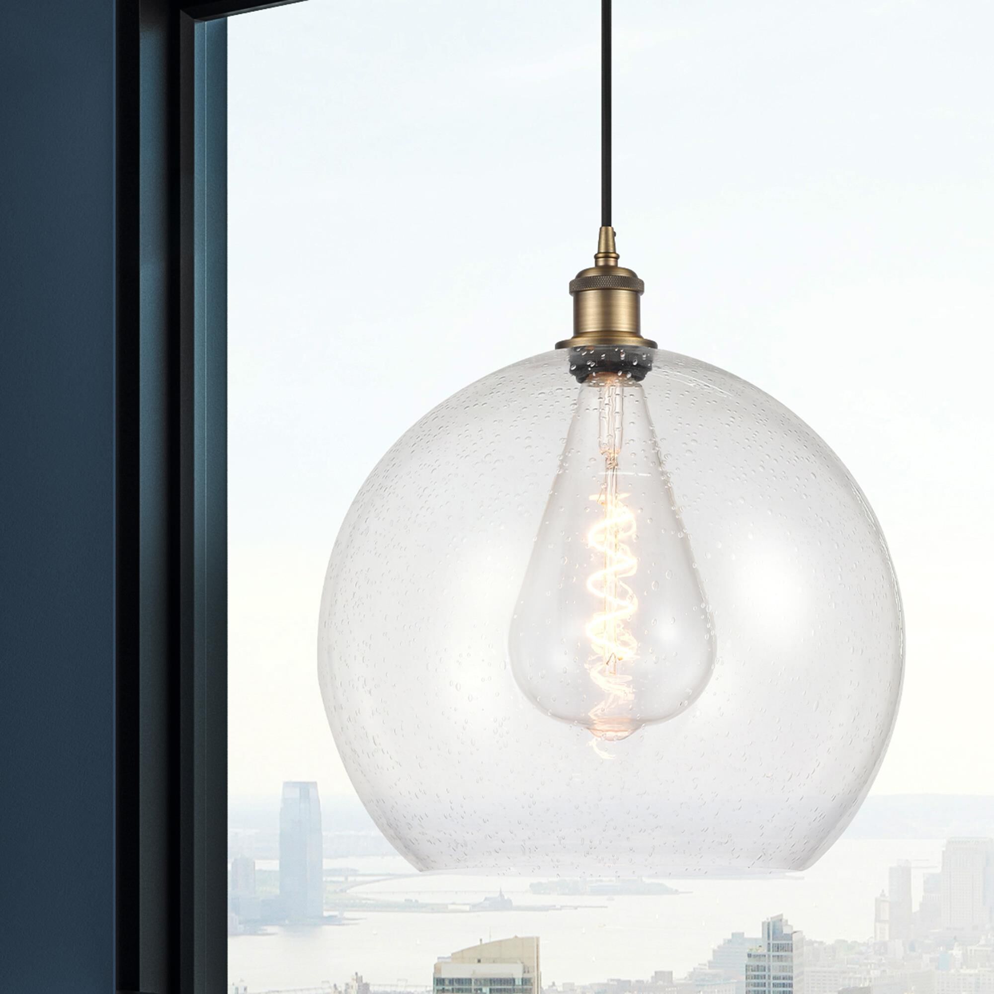 Shown in Brushed Brass finish and Seedy glass