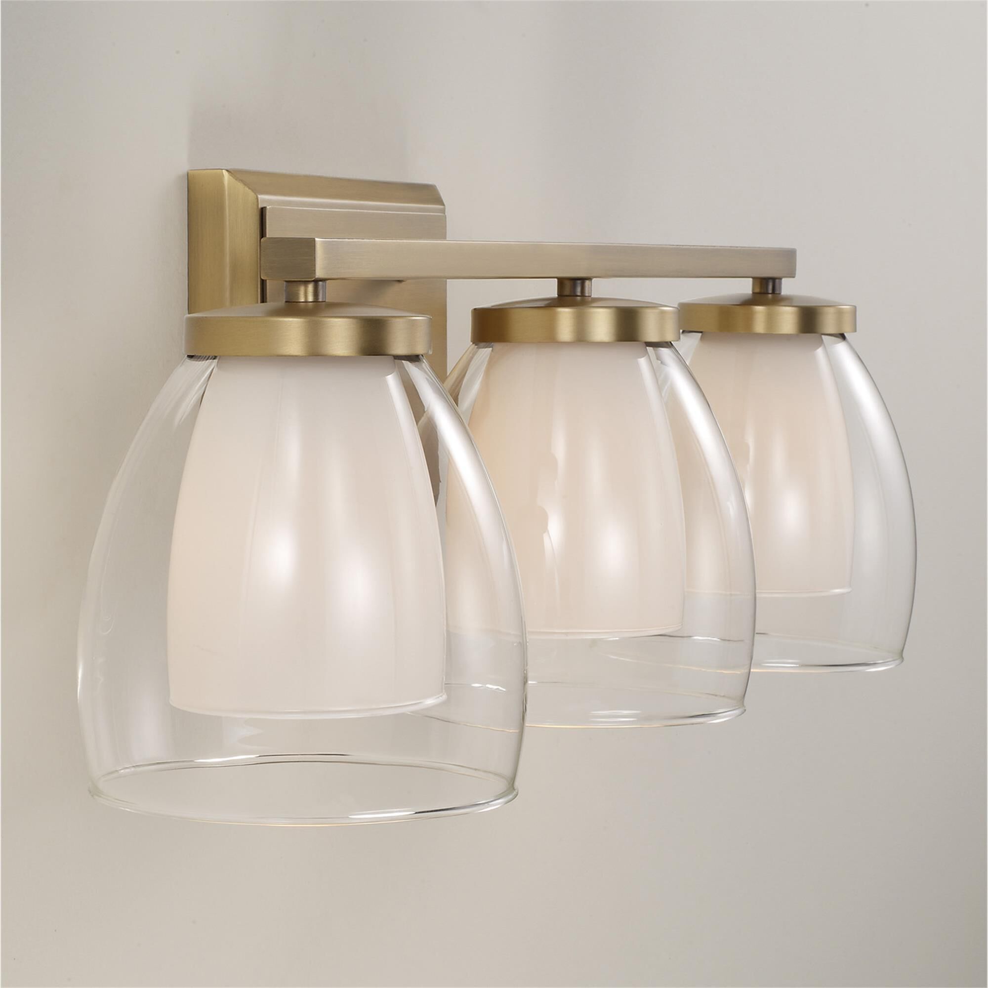 Shown in Aged Brass finish and Layered White And Clear glass