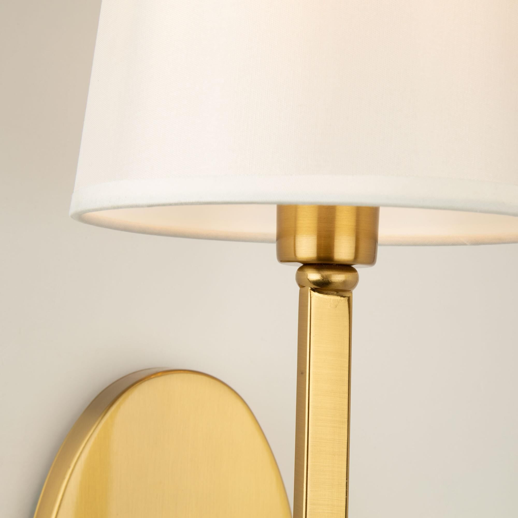 Shown in Brushed Gold finish and White Linen shade
