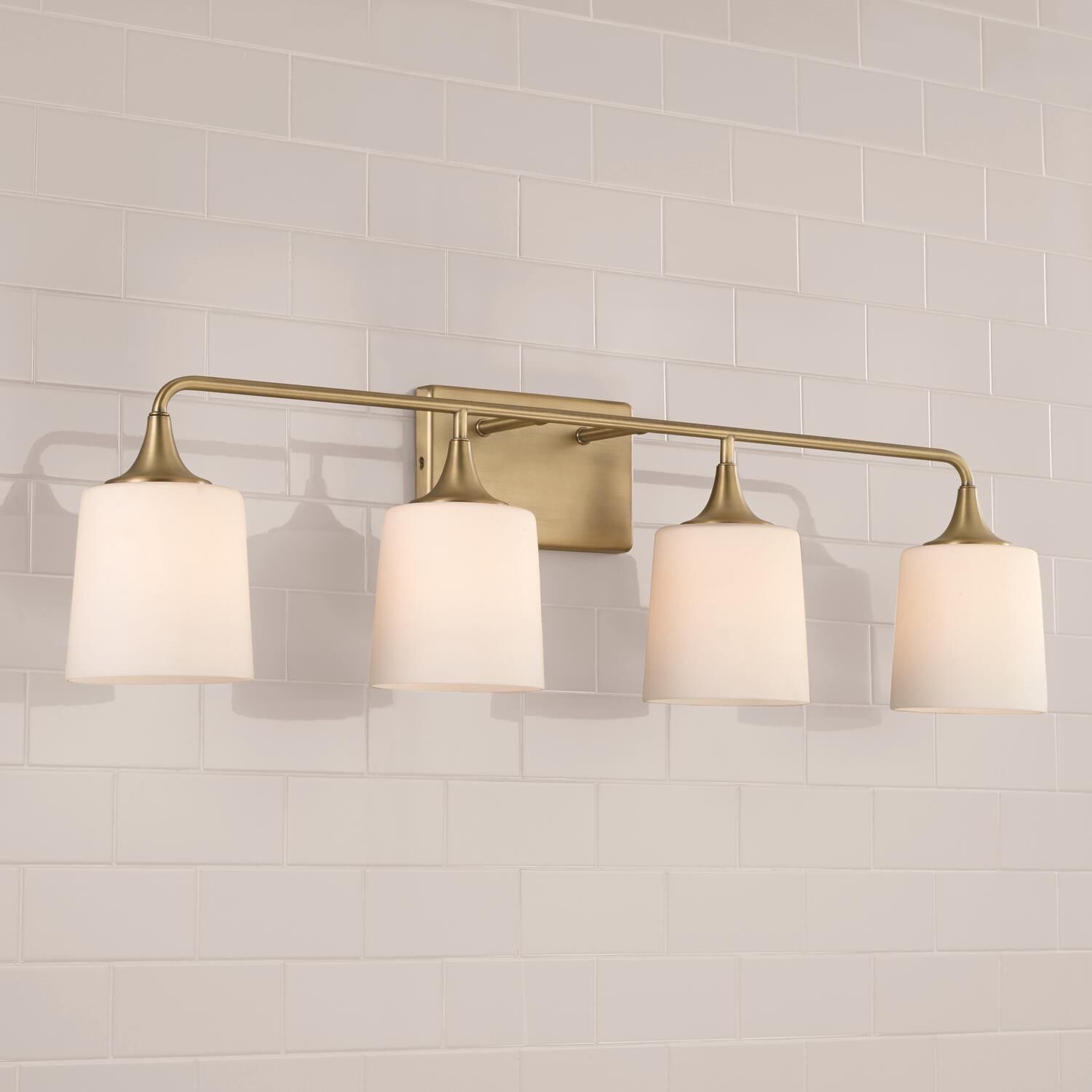 Shown in Aged Brass finish and Soft White glass