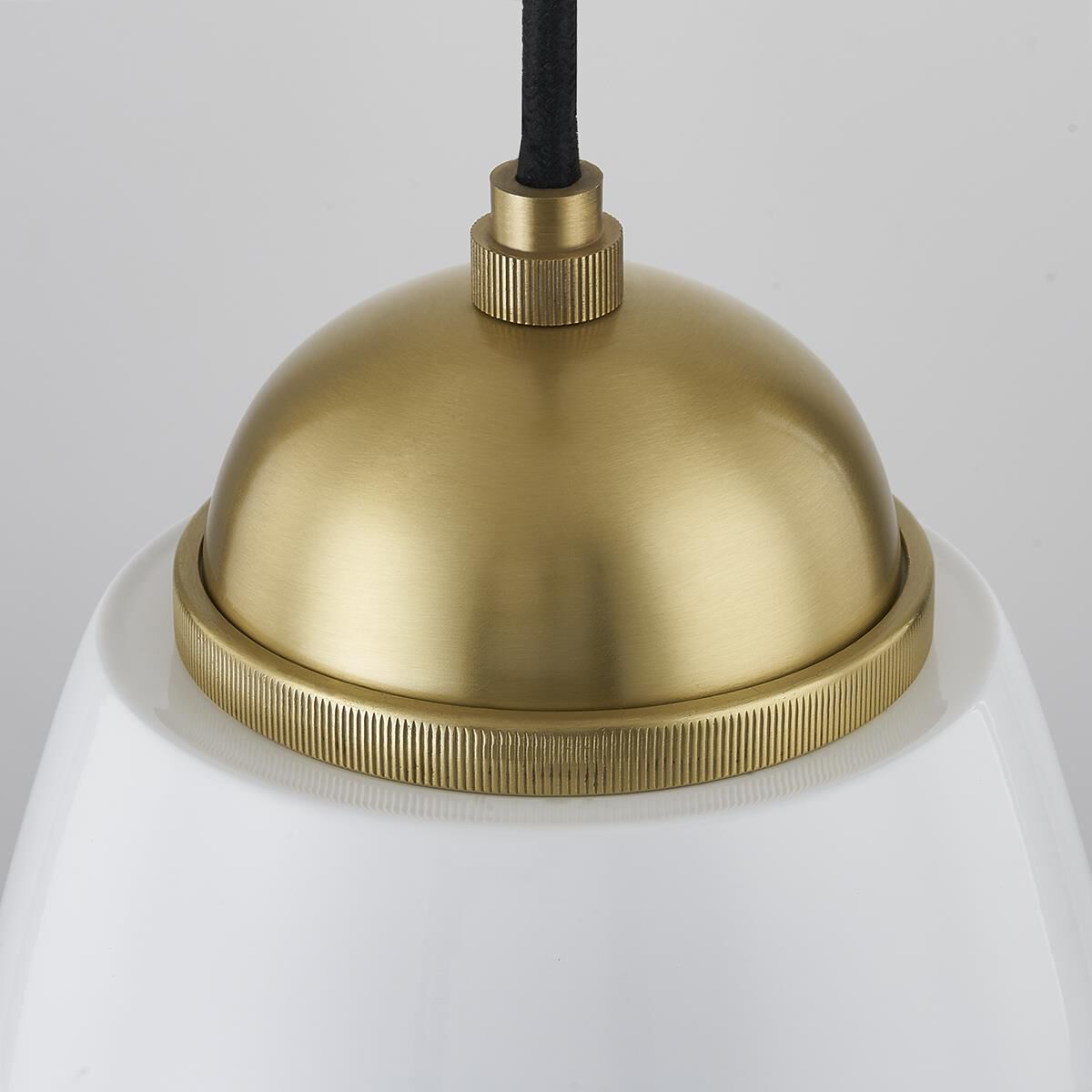 Shown in Aged Brass finish and Glossy White Metal shade