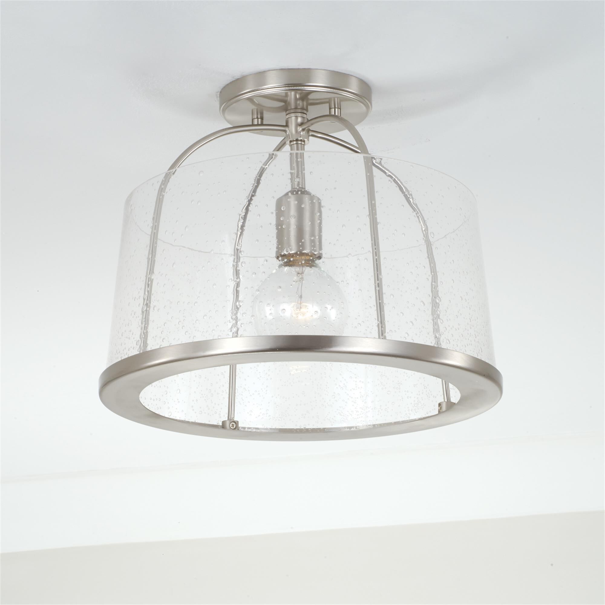 Shown in Brushed Nickel finish and Clear Seeded glass