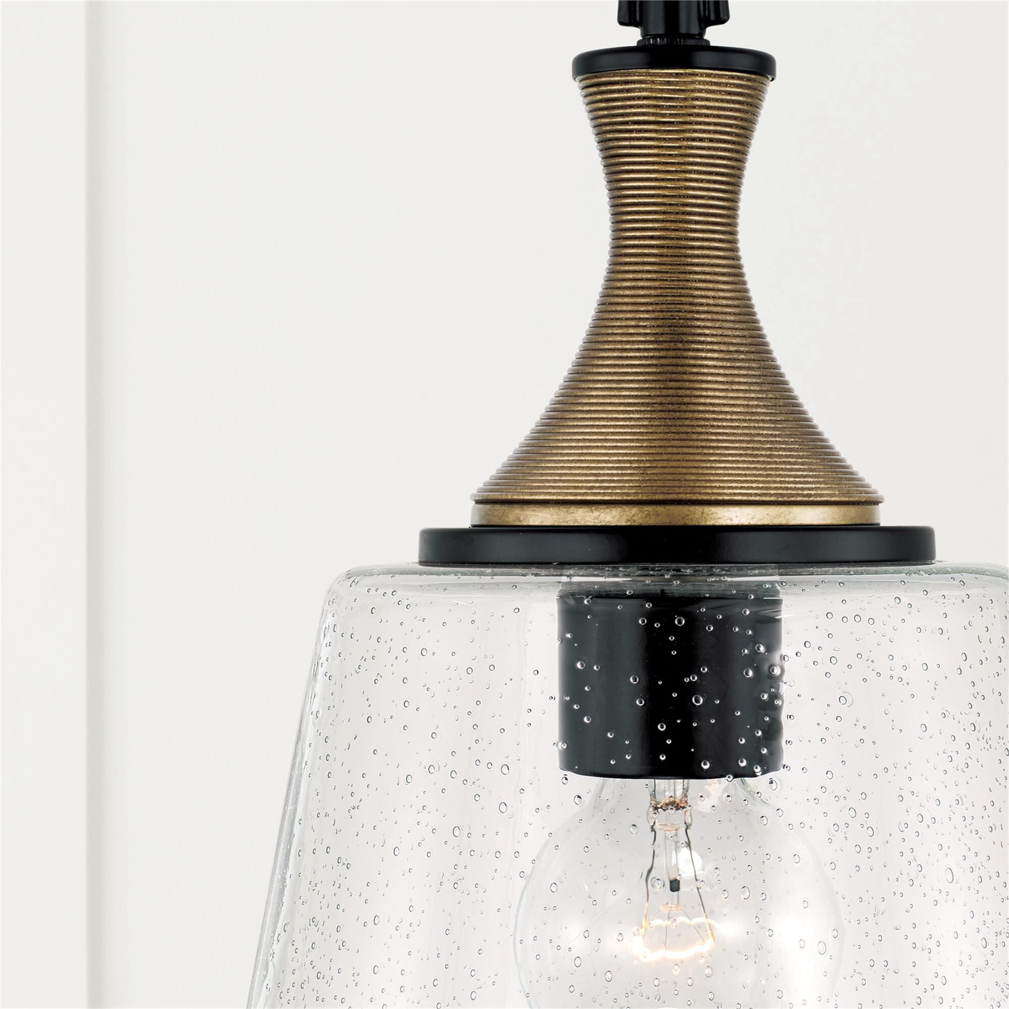 Shown in Matte Black With Brass finish and Clear Seeded glass