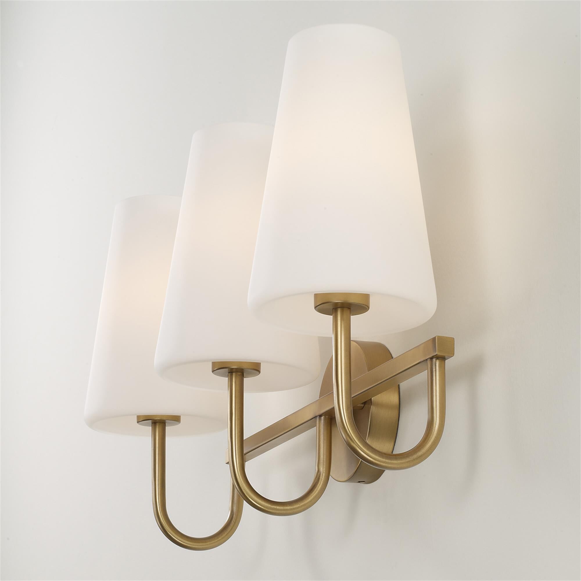 Shown in Aged Brass finish and Soft White glass