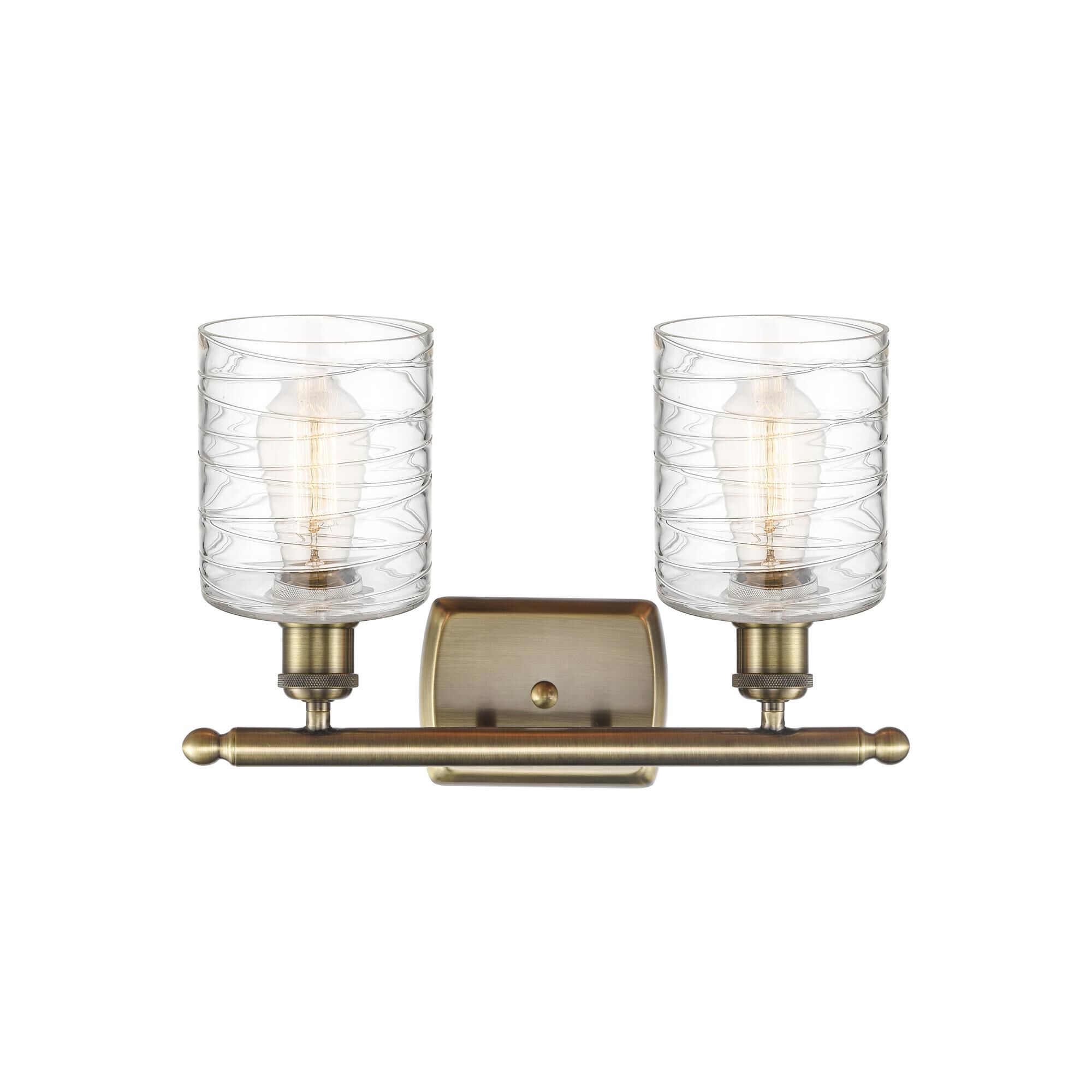 Shown in Antique Brass finish and Deco Swirl glass