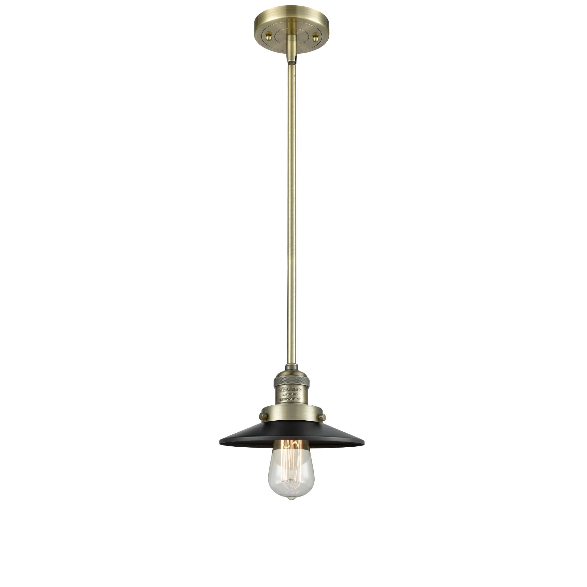 Shown in Antique Brass finish and Matte Black shade