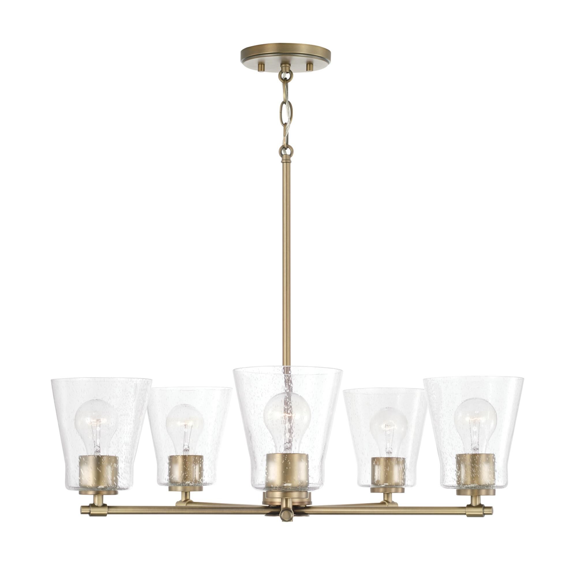 Shown in Aged Brass finish and Clear Seeded glass