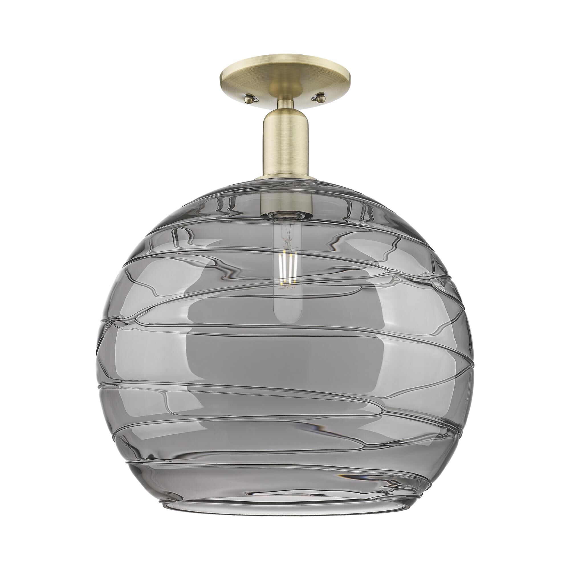 Shown in Antique Brass finish and Light Smoke Deco Swirl glass