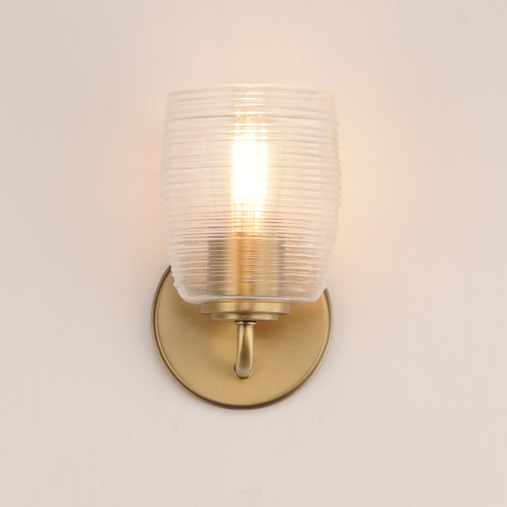 Shown in Natural Aged Brass finish and Clear Ribbed glass