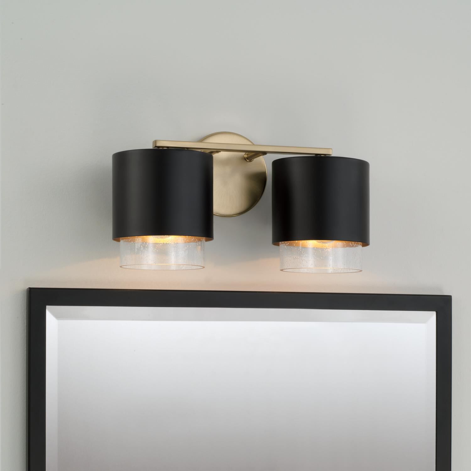 Shown in Matte Brass and Black finish and Clear Seeded glass and Metal with Brass Interior shade