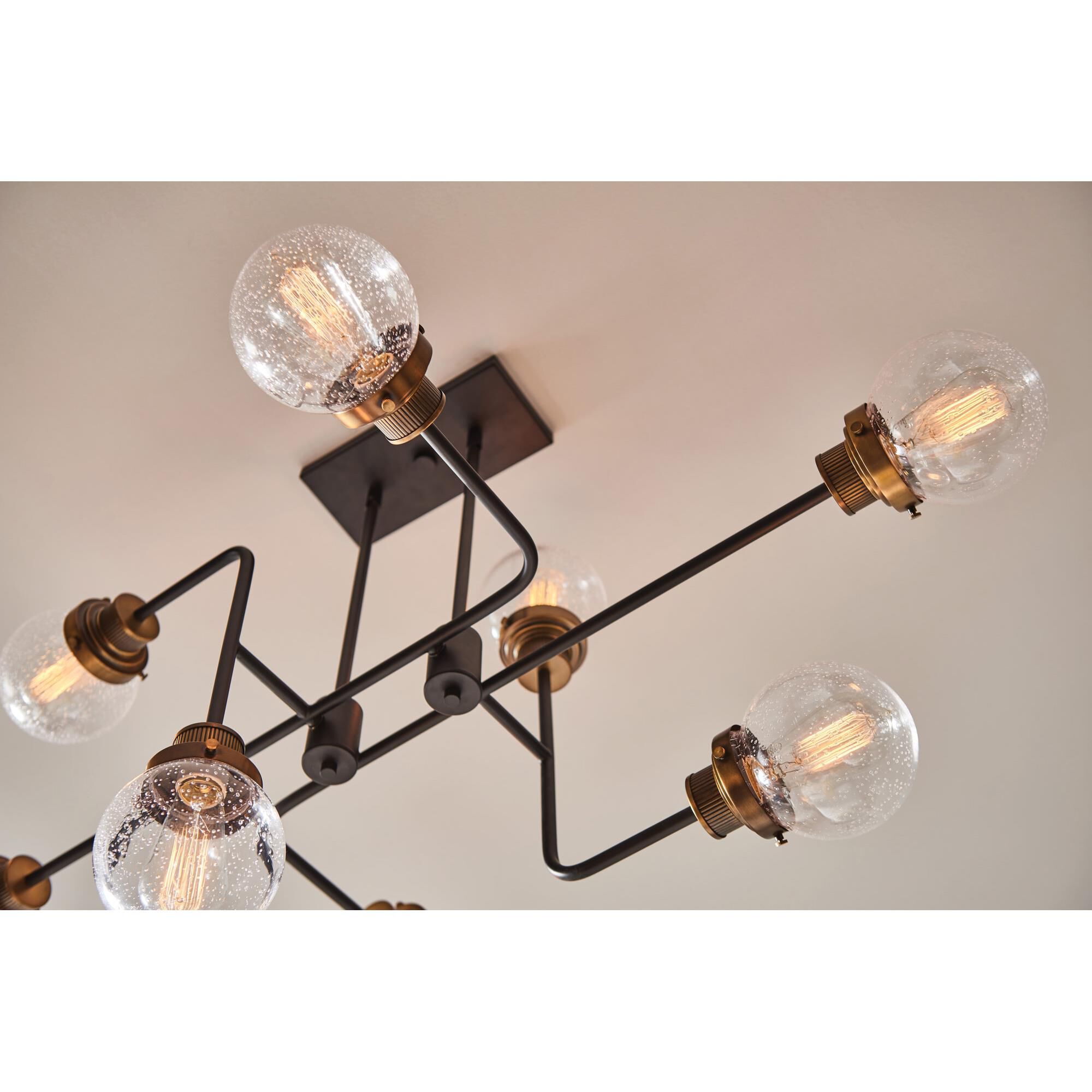 Shown in Black finish and Clear Seedy glass and Heritage Brass accent